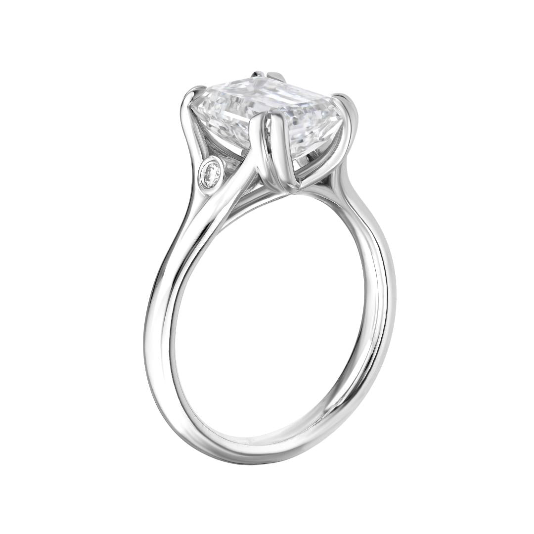 14K white gold emerald cut diamond engagement ring with side stones, shiny finish, IGI certified.