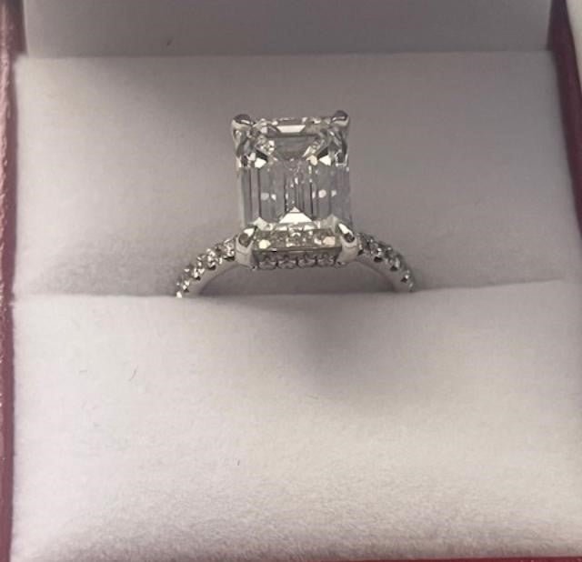 14K white gold emerald cut lab diamond engagement ring with sparkling side stones, IGI certified, shiny finish.
