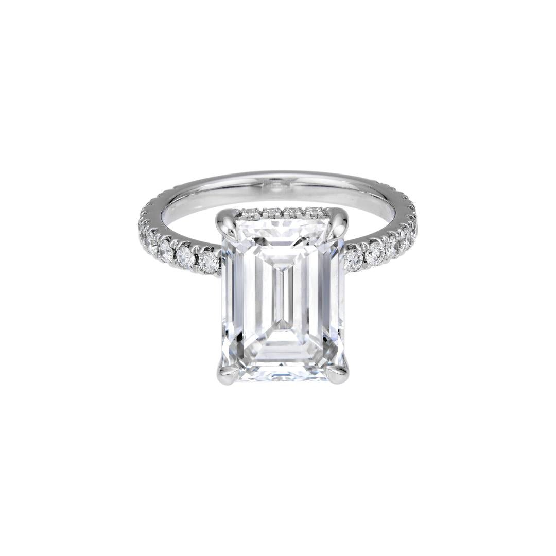 14K white gold engagement ring featuring a 4ct emerald cut lab diamond and diamond accents, shiny finish.