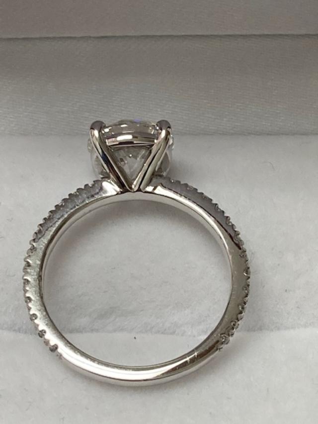 14K white gold round cut lab diamond engagement ring with a shiny finish and IGI certification.