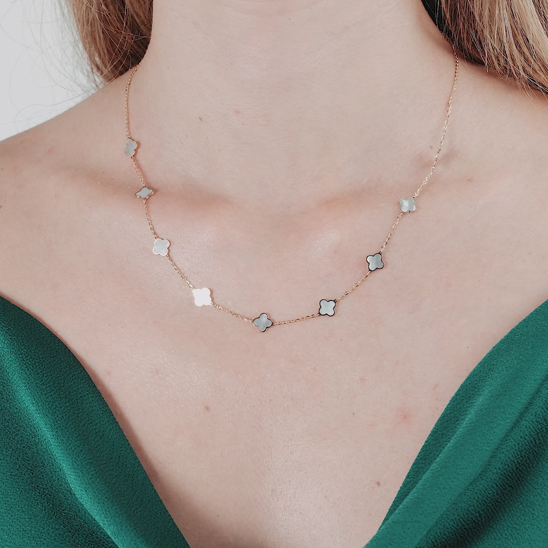 14K yellow gold mother of pearl four leaf clover necklace worn on a model, featuring a stunning design and thick chain.