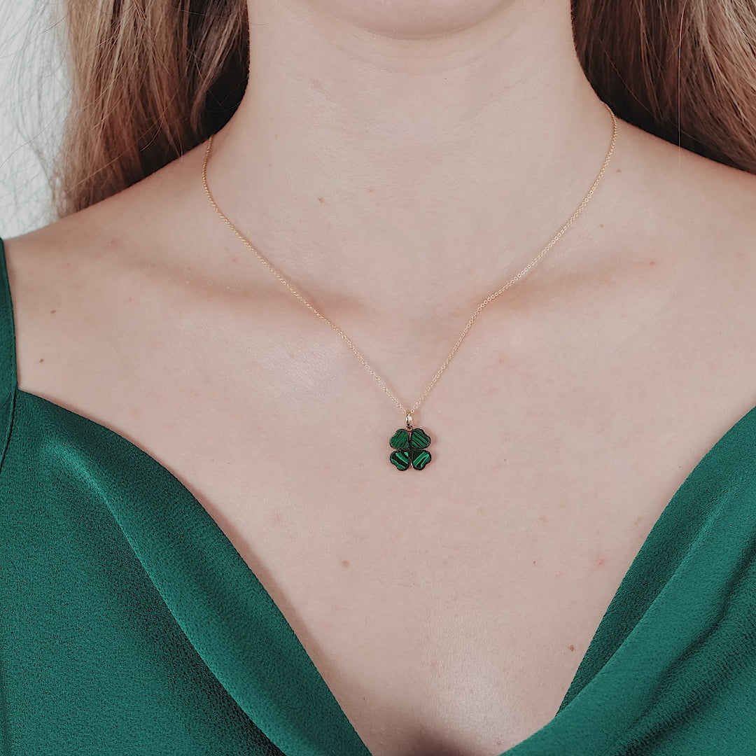 14K yellow gold malachite four leaf clover pendant necklace worn on a model, featuring a delicate design.