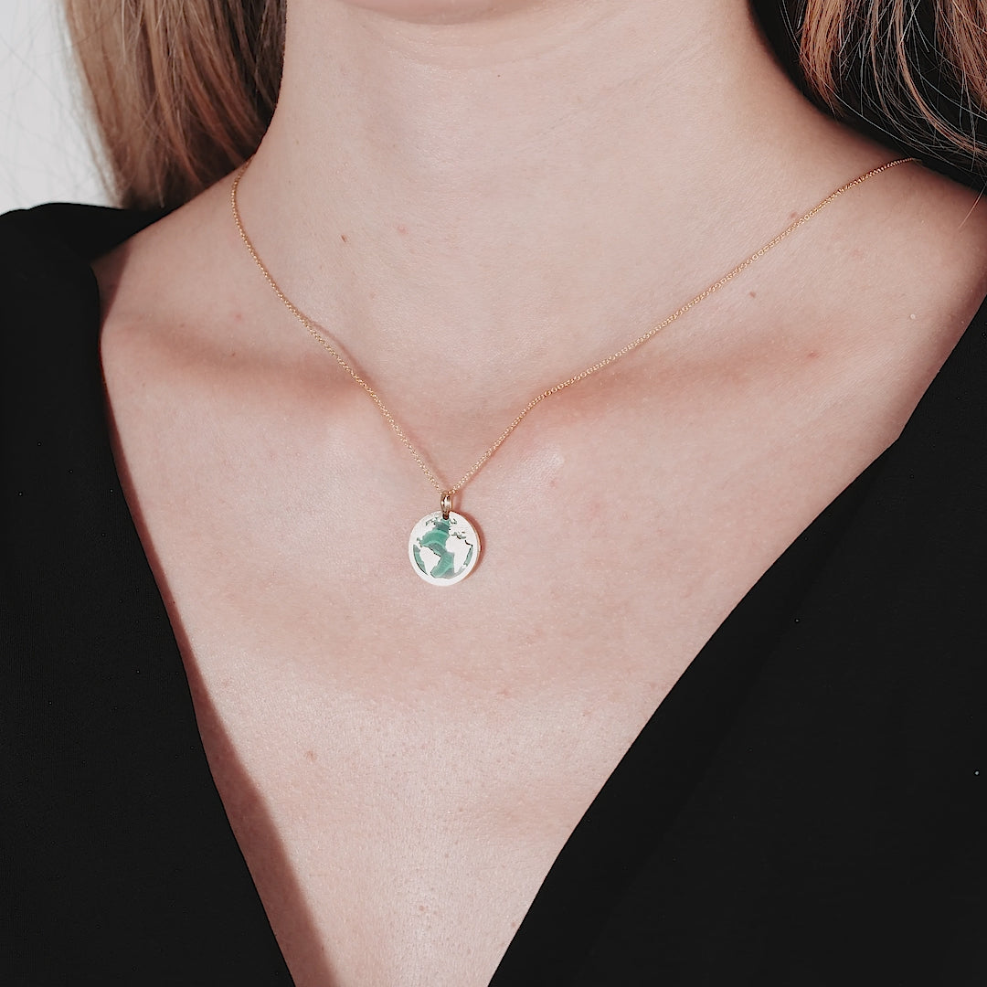 14K yellow gold malachite world map necklace worn elegantly, showcasing a dainty and stylish Earth pendant.
