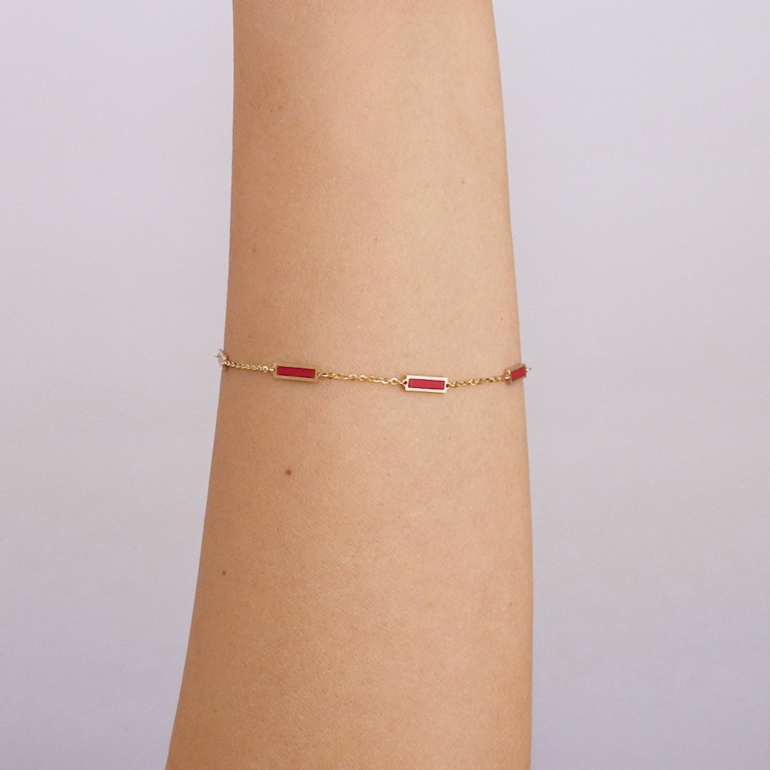 14K solid yellow gold bracelet with red coral bars, 7 inches long, elegantly displayed on a wrist.