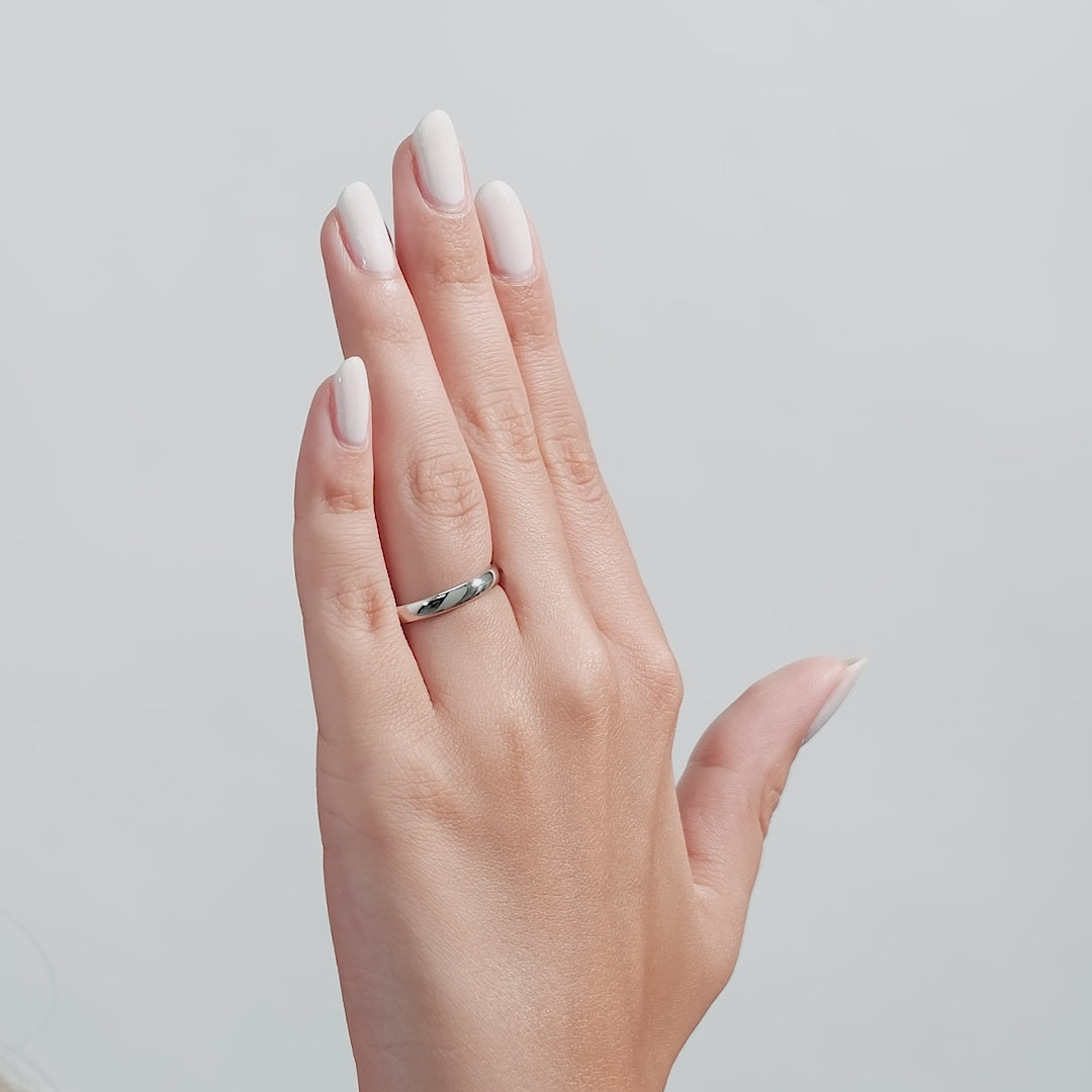 Model wearing a 3mm solid white gold plain dome wedding band with a shiny finish, showcasing elegant wedding jewelry.