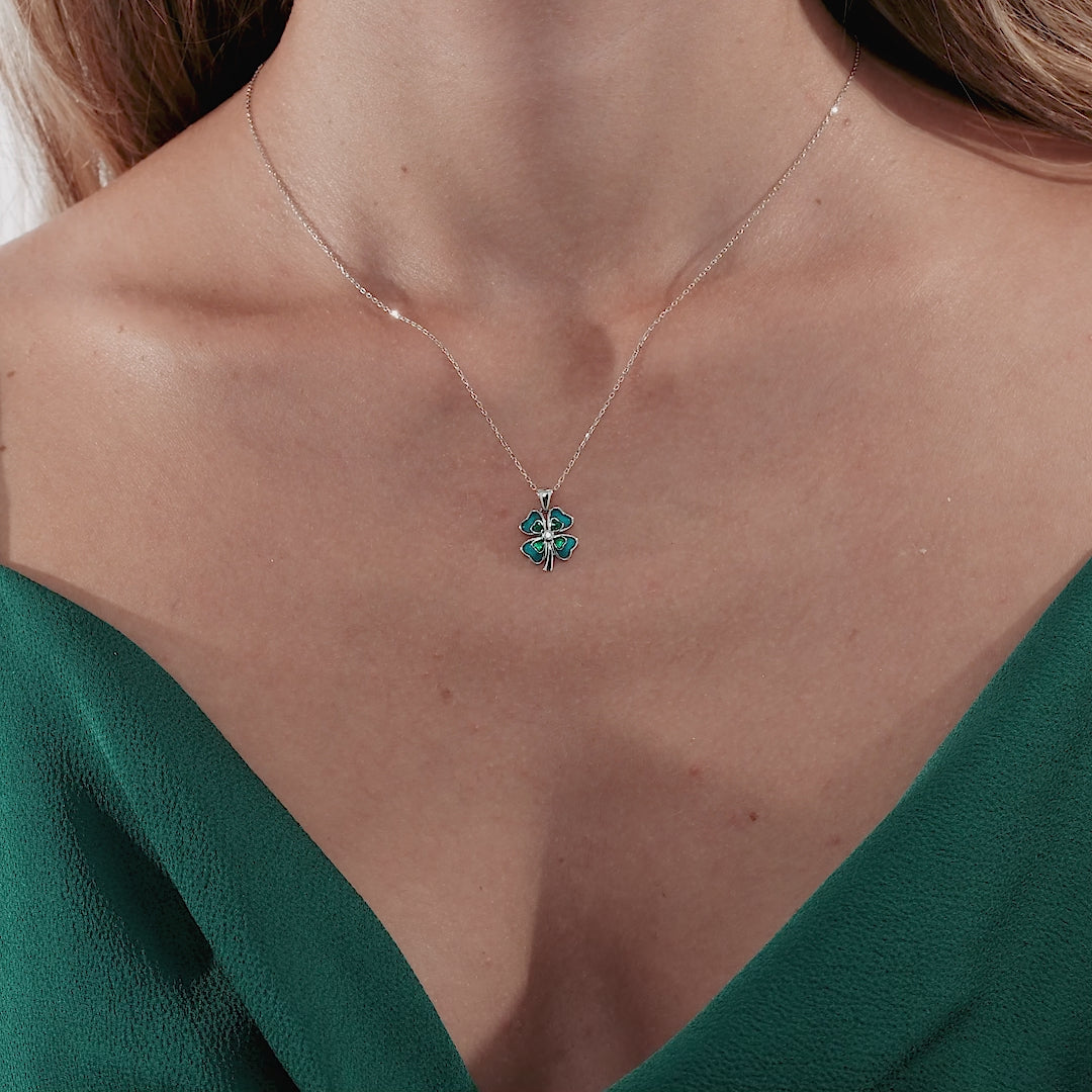 14K solid white gold enamel four leaf clover necklace worn by a woman, featuring a delicate design.