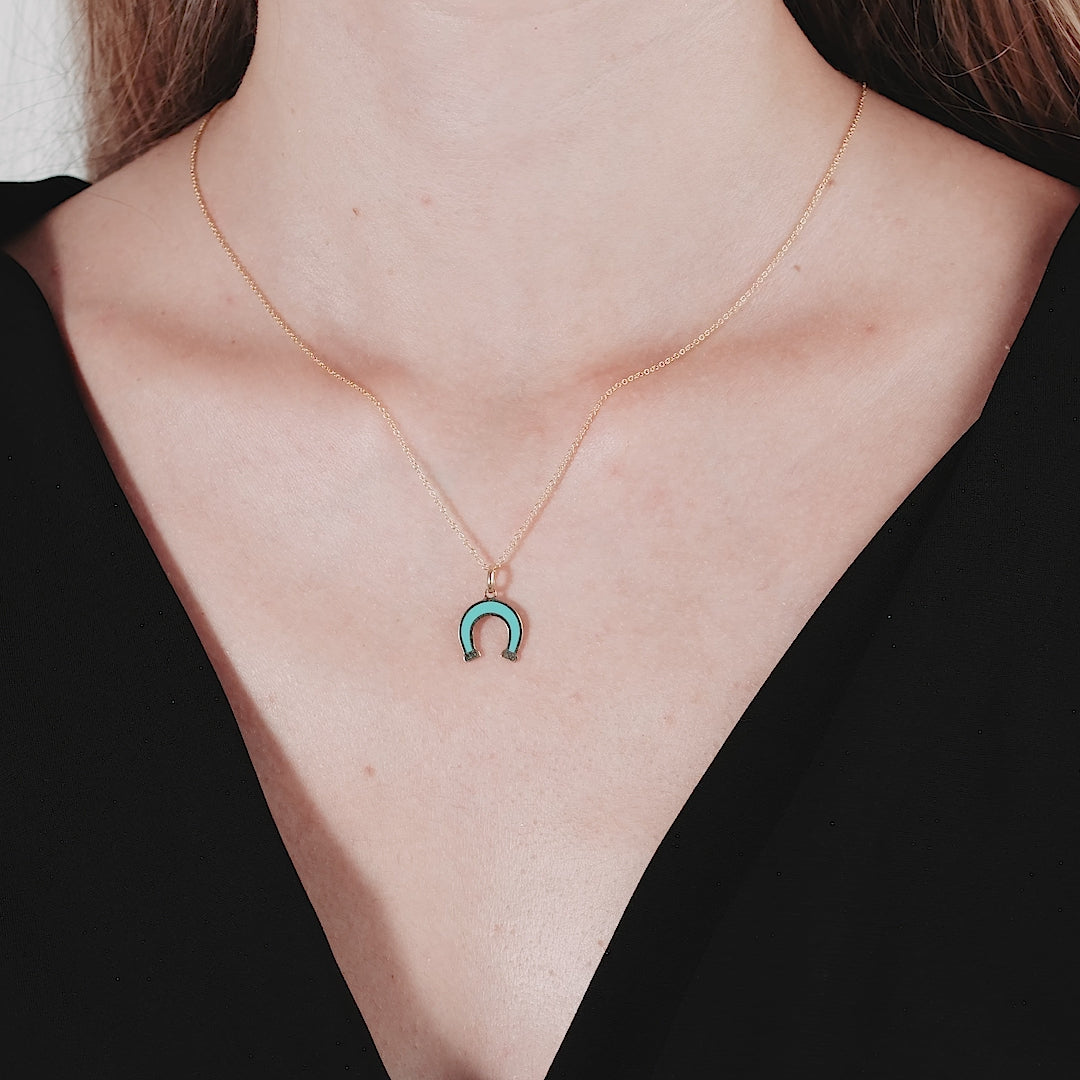 14K yellow gold turquoise horseshoe necklace worn elegantly, showcasing its delicate design and vibrant color.