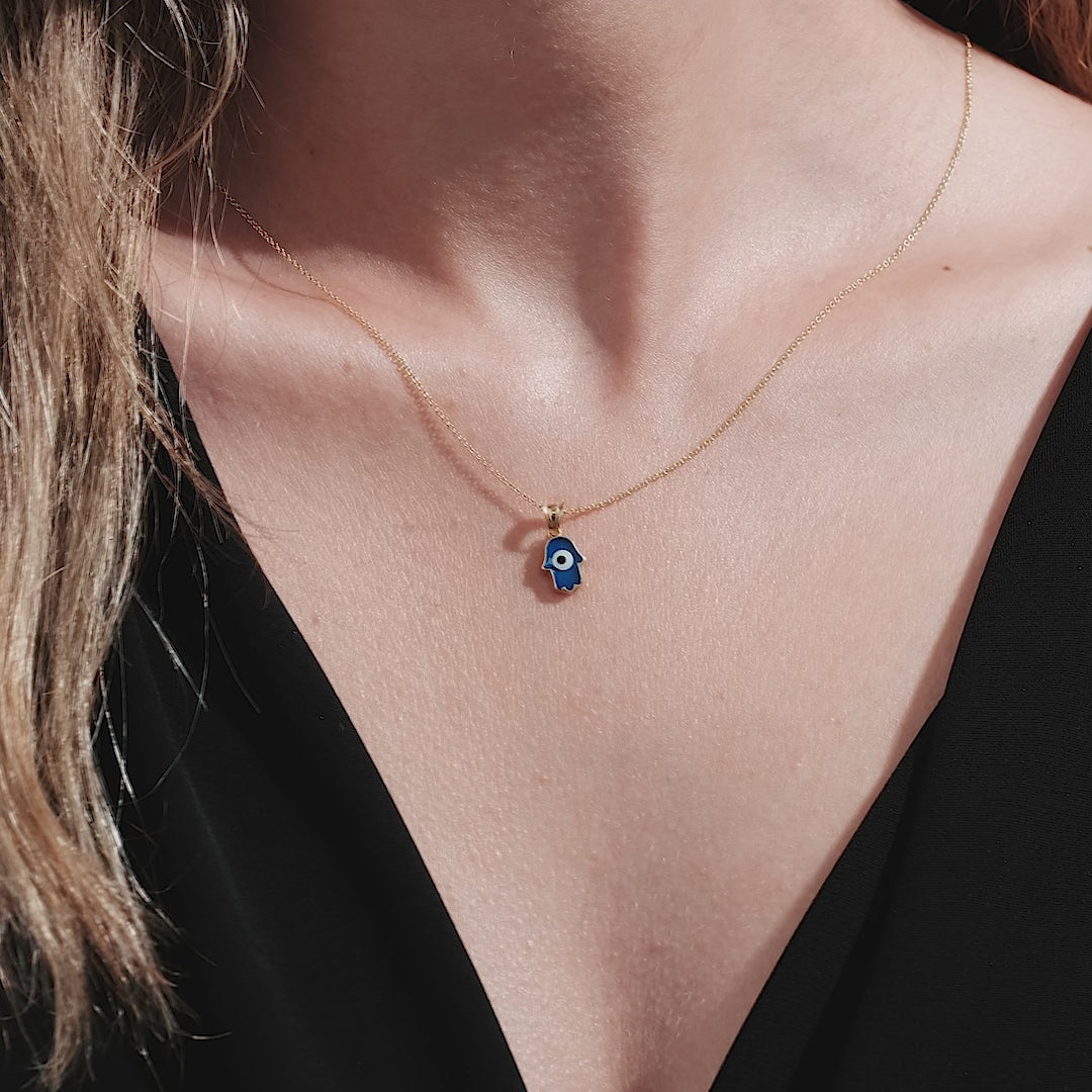 Dainty 14K yellow gold Hamsa necklace featuring an elegant blue enamel pendant, perfect for everyday wear.