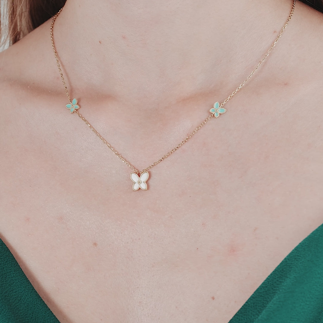 14K yellow gold enamel butterfly necklace worn on a model, featuring a large and small butterfly design.