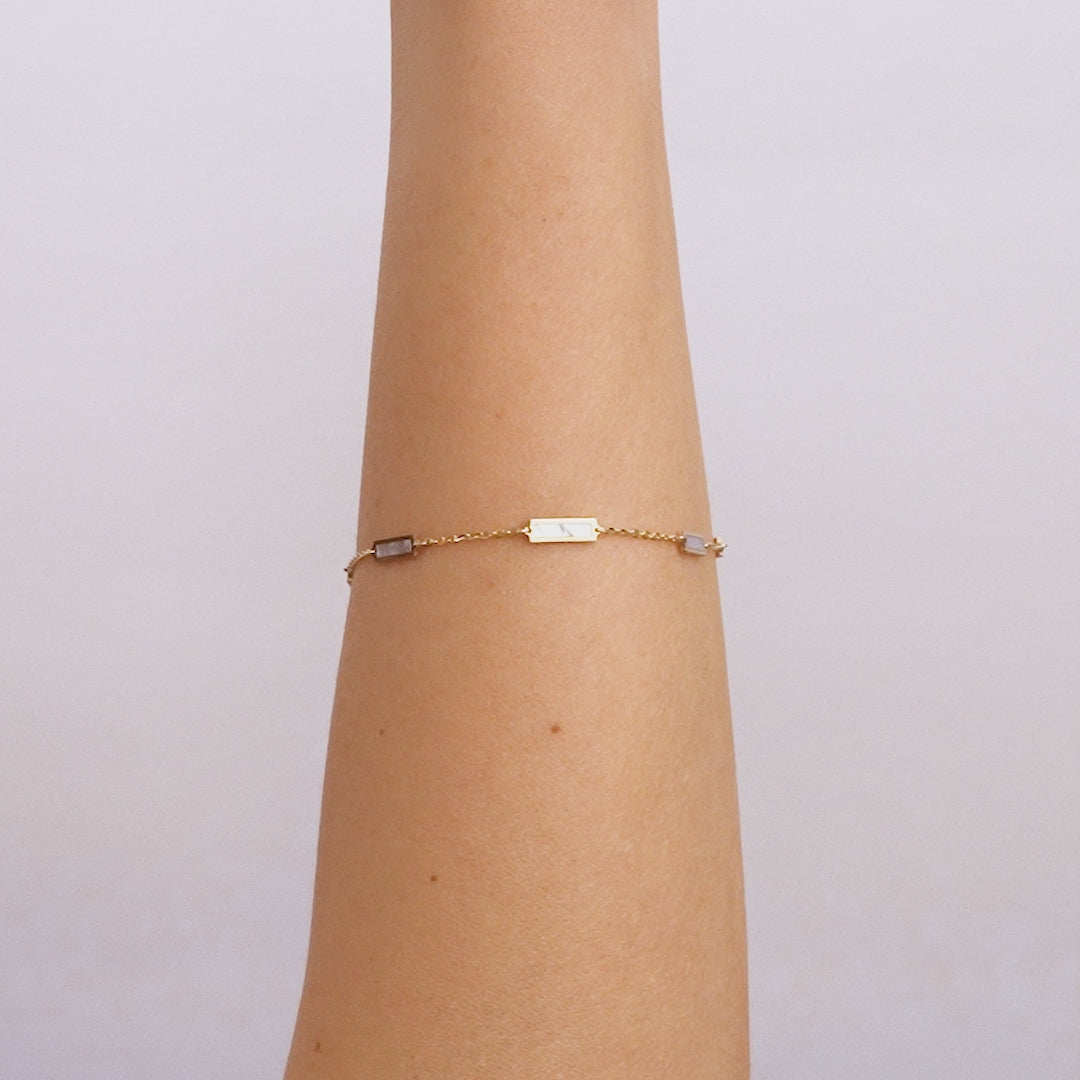 14K solid yellow gold mother of pearl bar bracelet on a wrist, featuring elegant design and lobster claw clasp, gift-ready.