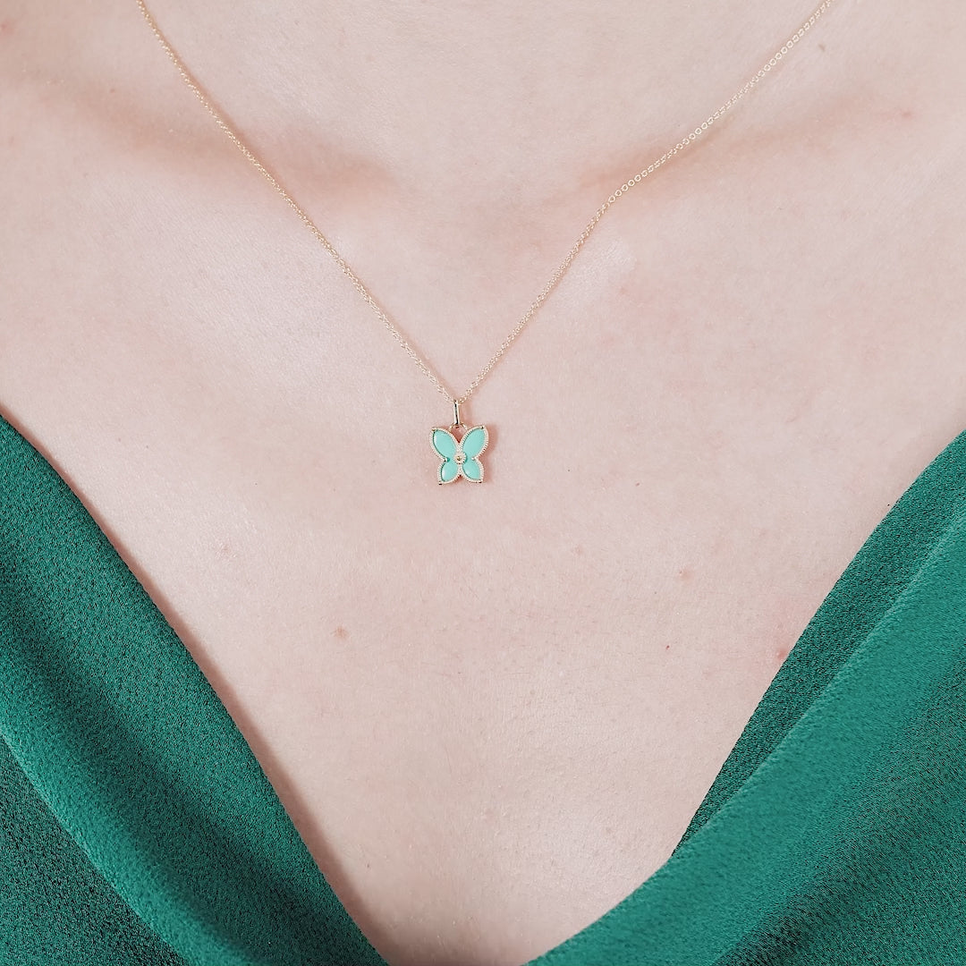 14K yellow gold butterfly necklace with teal enamel, perfect for everyday wear, styled on a model.