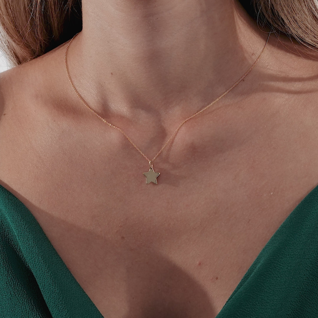 Dainty 14K solid yellow gold star necklace displayed on a model, featuring a minimalist design perfect for everyday wear.