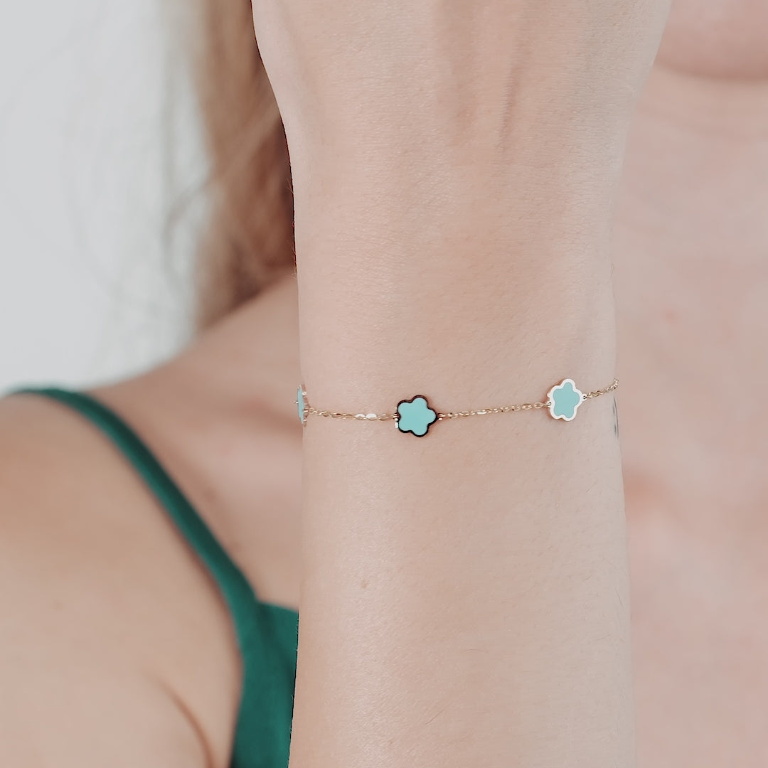 14K yellow gold bracelet with turquoise blossoms showcased on a model's wrist, perfect for everyday elegance.