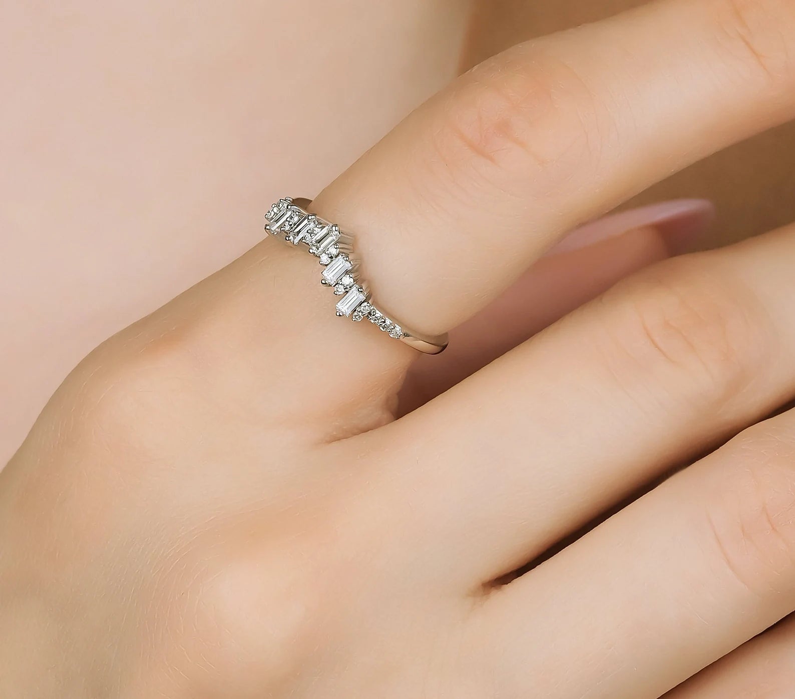 14K solid gold baguette and round diamond ring worn on hand, showcasing elegance and sparkle.