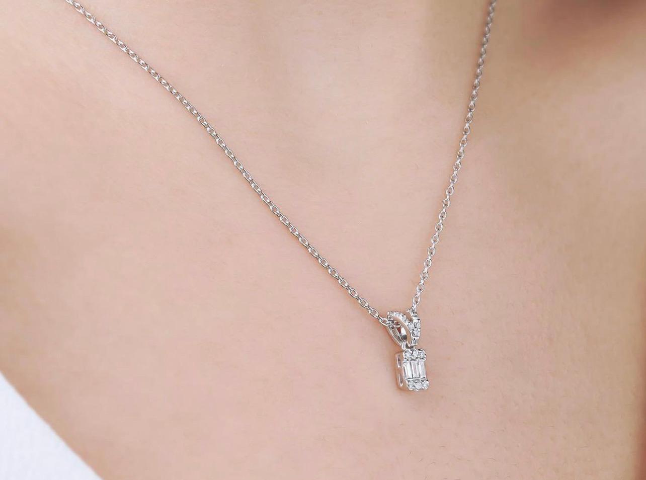 14K Gold solitaire baguette diamond necklace worn, featuring a sparkling diamond pendant and delicate chain.