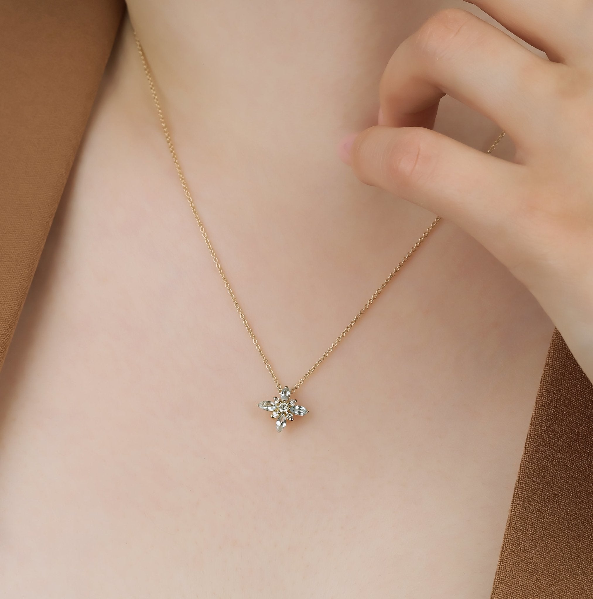14K gold marquise topaz and diamond necklace worn by a model, showcasing its elegant design and delicate charm.