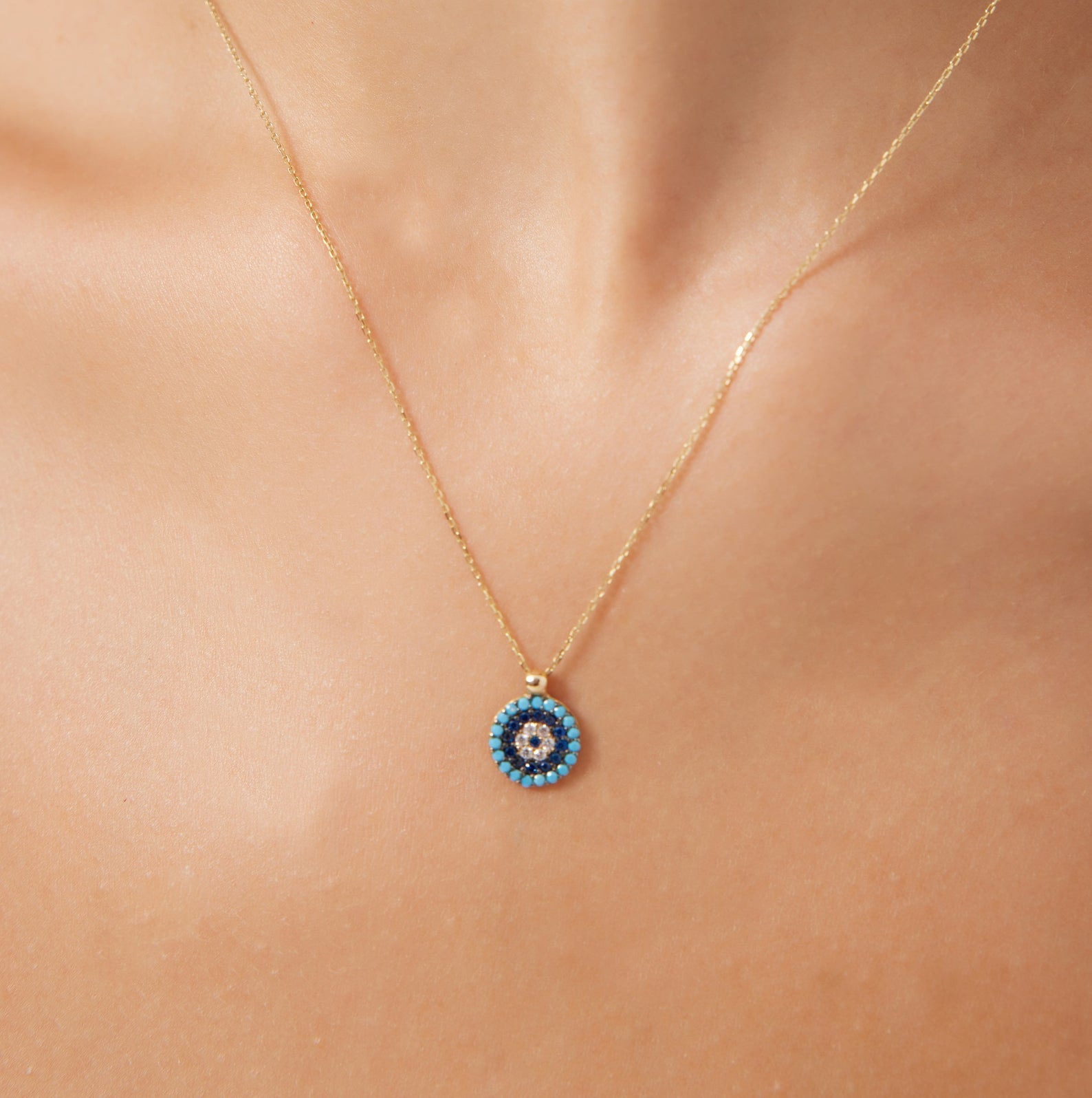 14K yellow gold turquoise evil eye necklace with CZ stones, dainty design perfect for everyday wear.