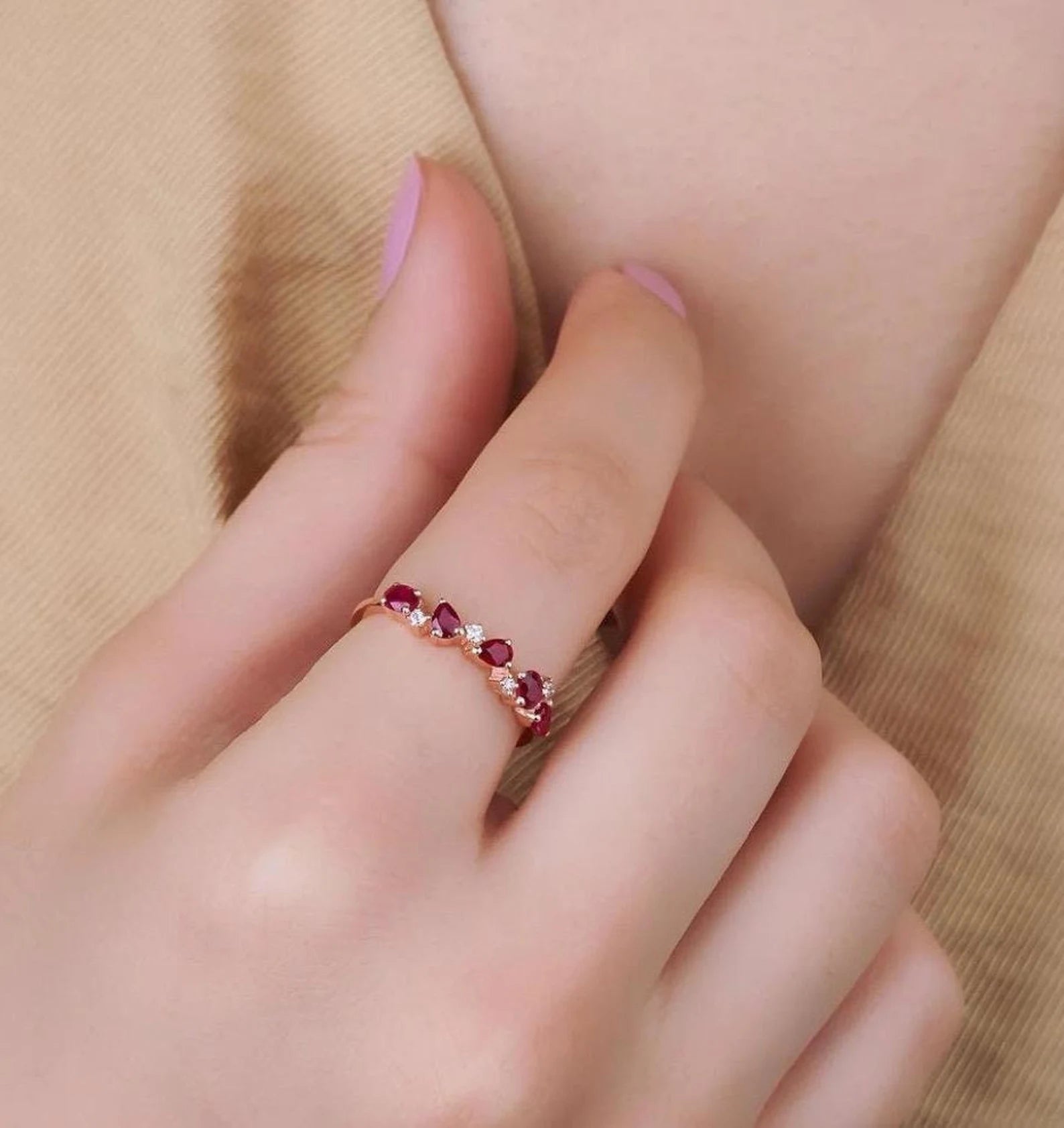 14K gold wedding ring featuring pear shape rubies and diamonds, perfect for everyday elegance.