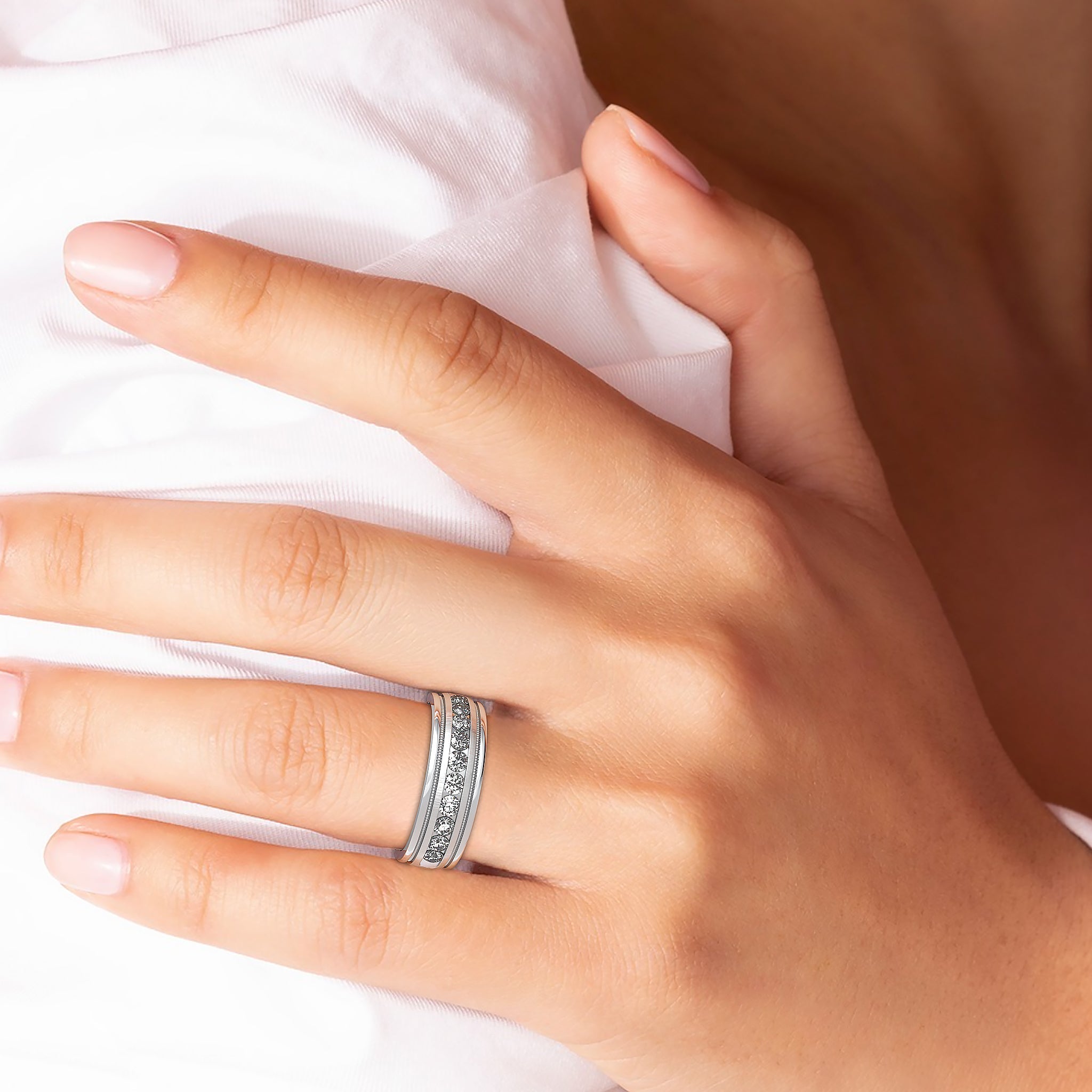 14K solid rose gold men's wedding band featuring 0.80 carats of diamonds worn on a hand, showcasing shiny finish and milgrain design.