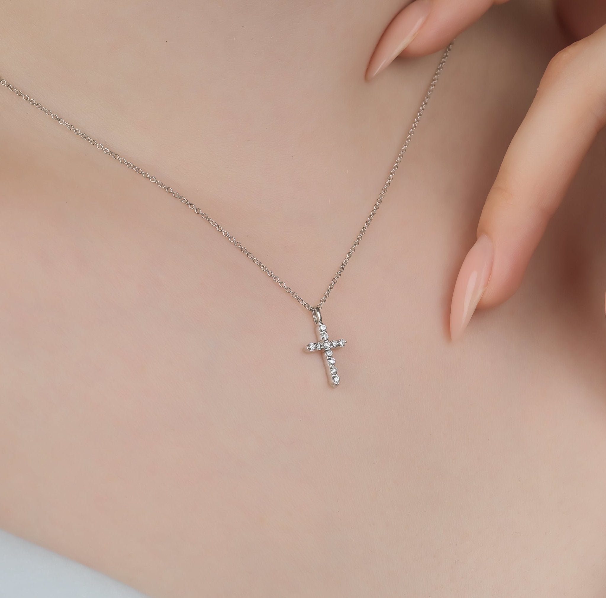 14K solid white gold diamond cross necklace worn on a model, showcasing its minimalist design and elegant sparkle.