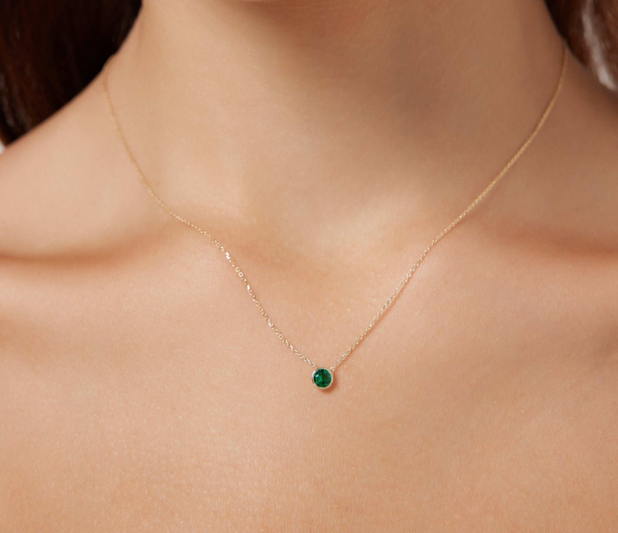 Dainty 14K solid white gold neckline featuring a 4mm bezel set solitaire emerald, ideal for everyday wear.
