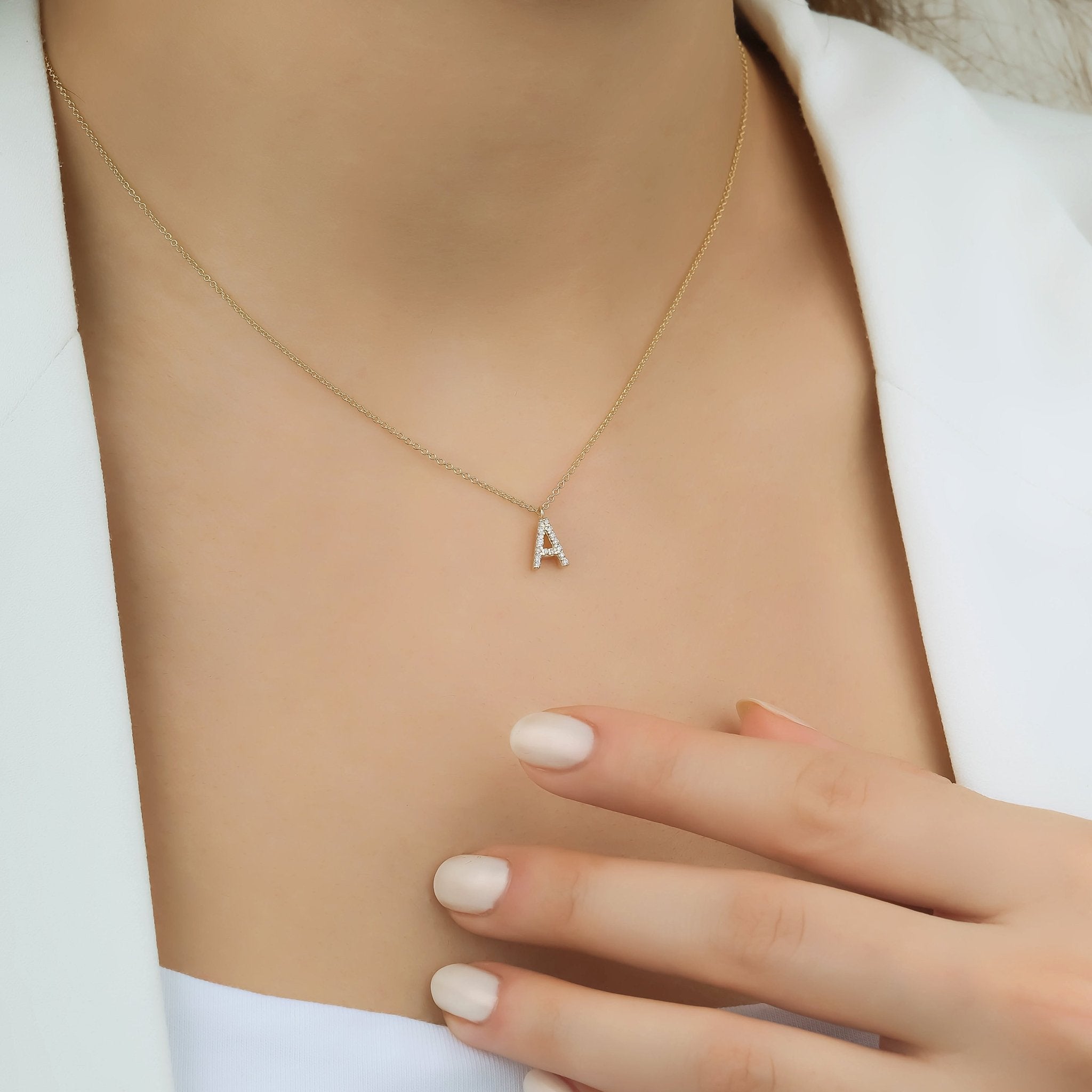 14K solid white gold letter A initial necklace worn on a model, showcasing a dainty and elegant design.
