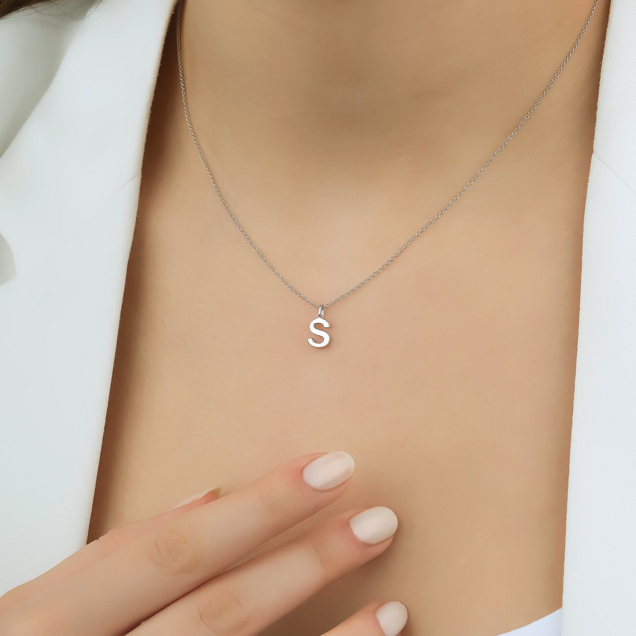 14K solid white gold initial necklace featuring a dainty letter S on a model's neck, perfect for personalized jewelry.