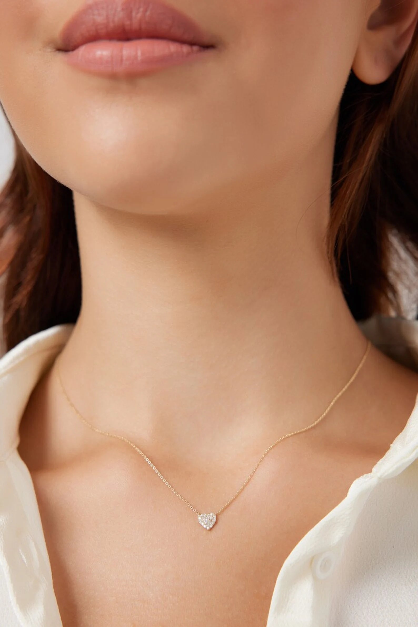 Dainty 14K solid white gold minimalist diamond heart necklace worn elegantly, showcasing its sparkle and delicate design.