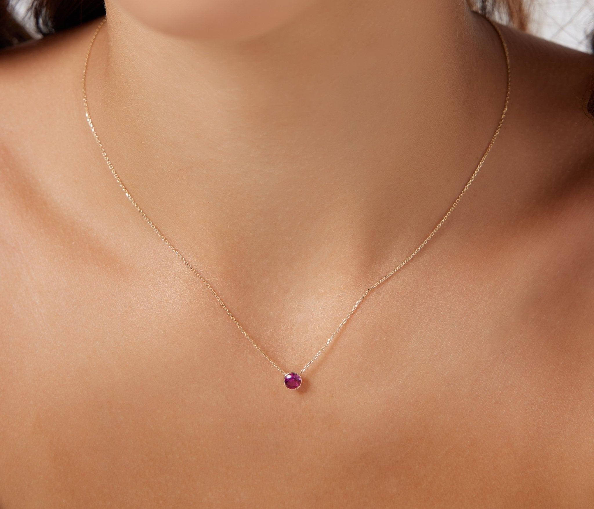 Delicate 14K White Gold 4mm Ruby Solitaire Necklace on model, perfect for minimalistic style and July birthdays.