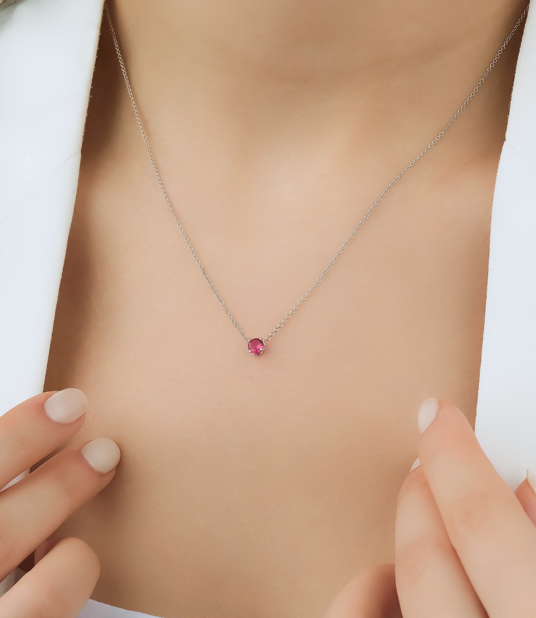 14K white gold 5mm prong setting solitaire ruby necklace worn on model's neck, showcasing the July birthstone.