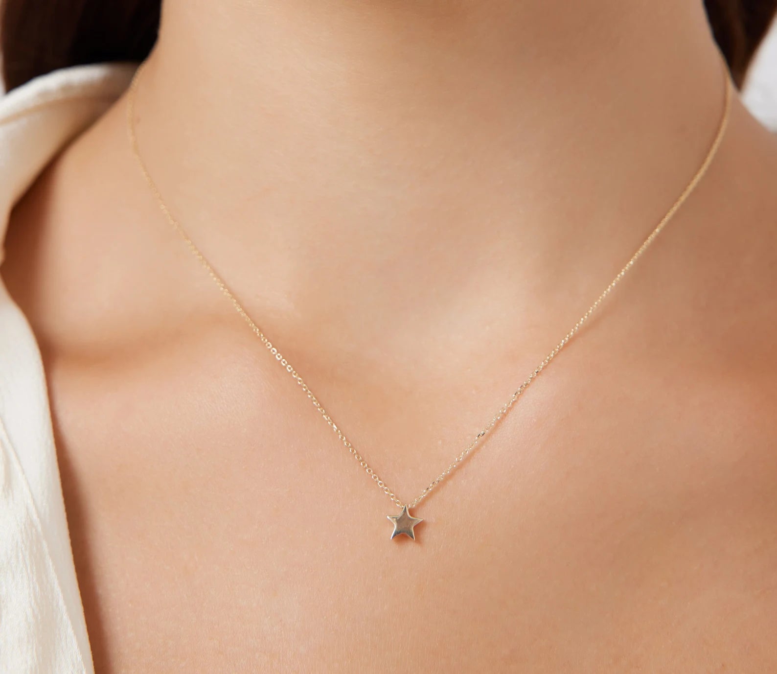 14K solid white gold minimalist star necklace worn on the neck, perfect for everyday elegance.
