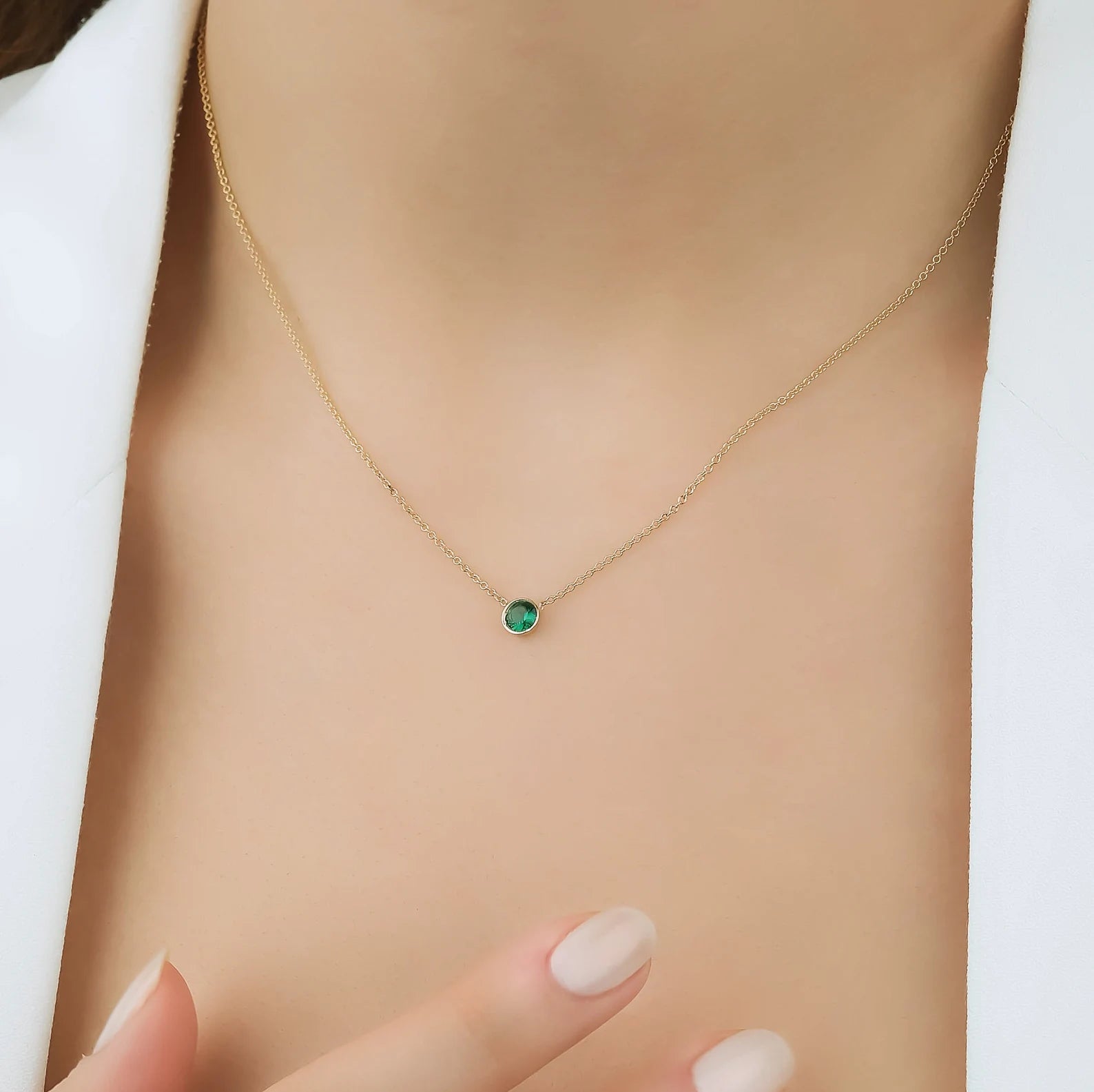 14K solid yellow gold 4mm bezel set minimalist emerald solitaire necklace worn around the neck, perfect for everyday use.