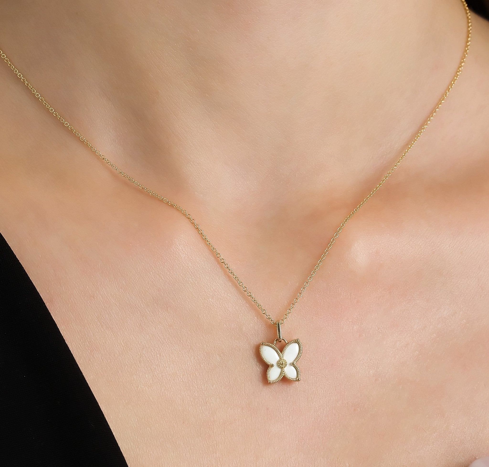 14K solid yellow gold dainty butterfly necklace with enamel pendant, worn on a model's neck, perfect for everyday use.
