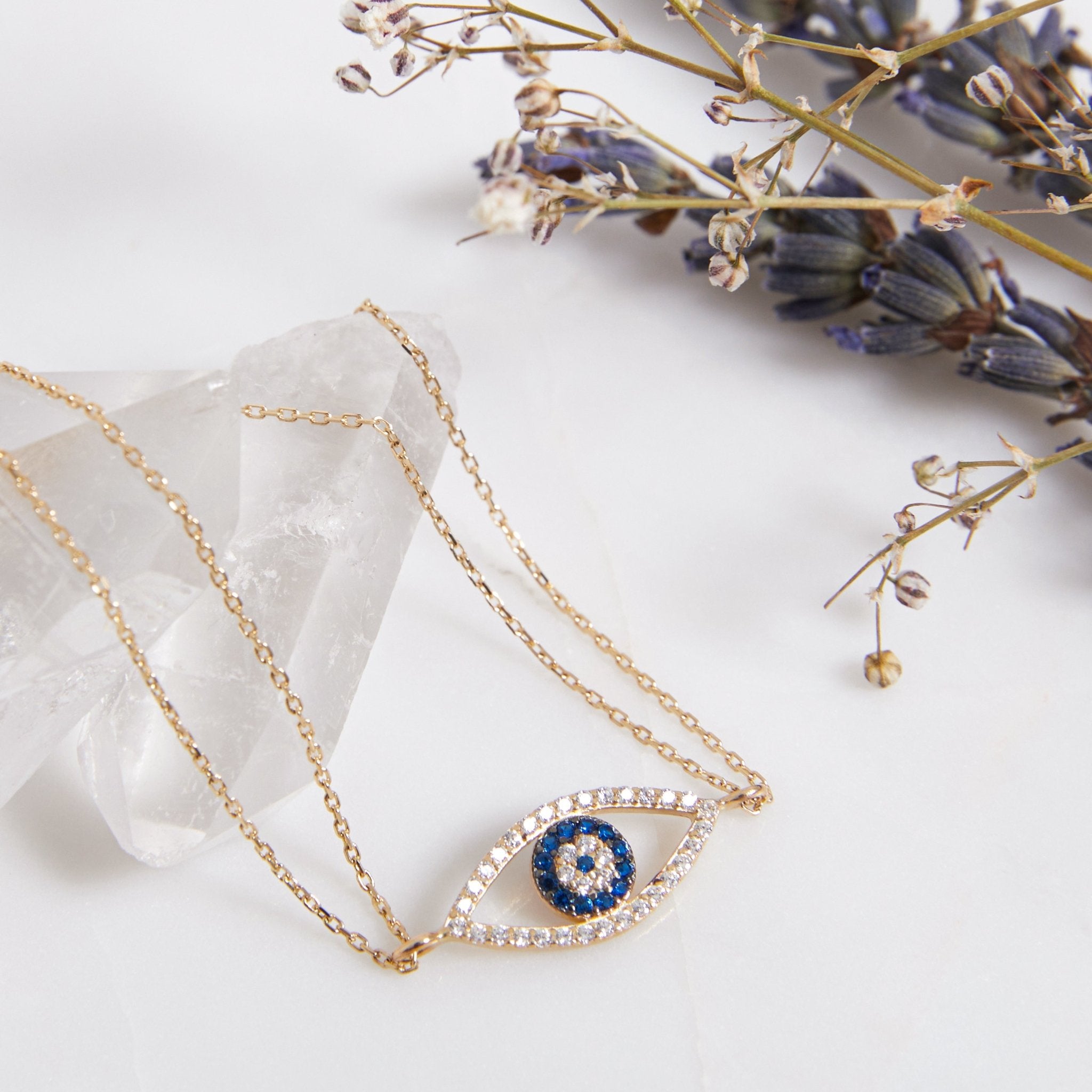 14K solid yellow gold evil eye bracelet with CZ, dainty design on a crystal base, perfect for everyday wear.