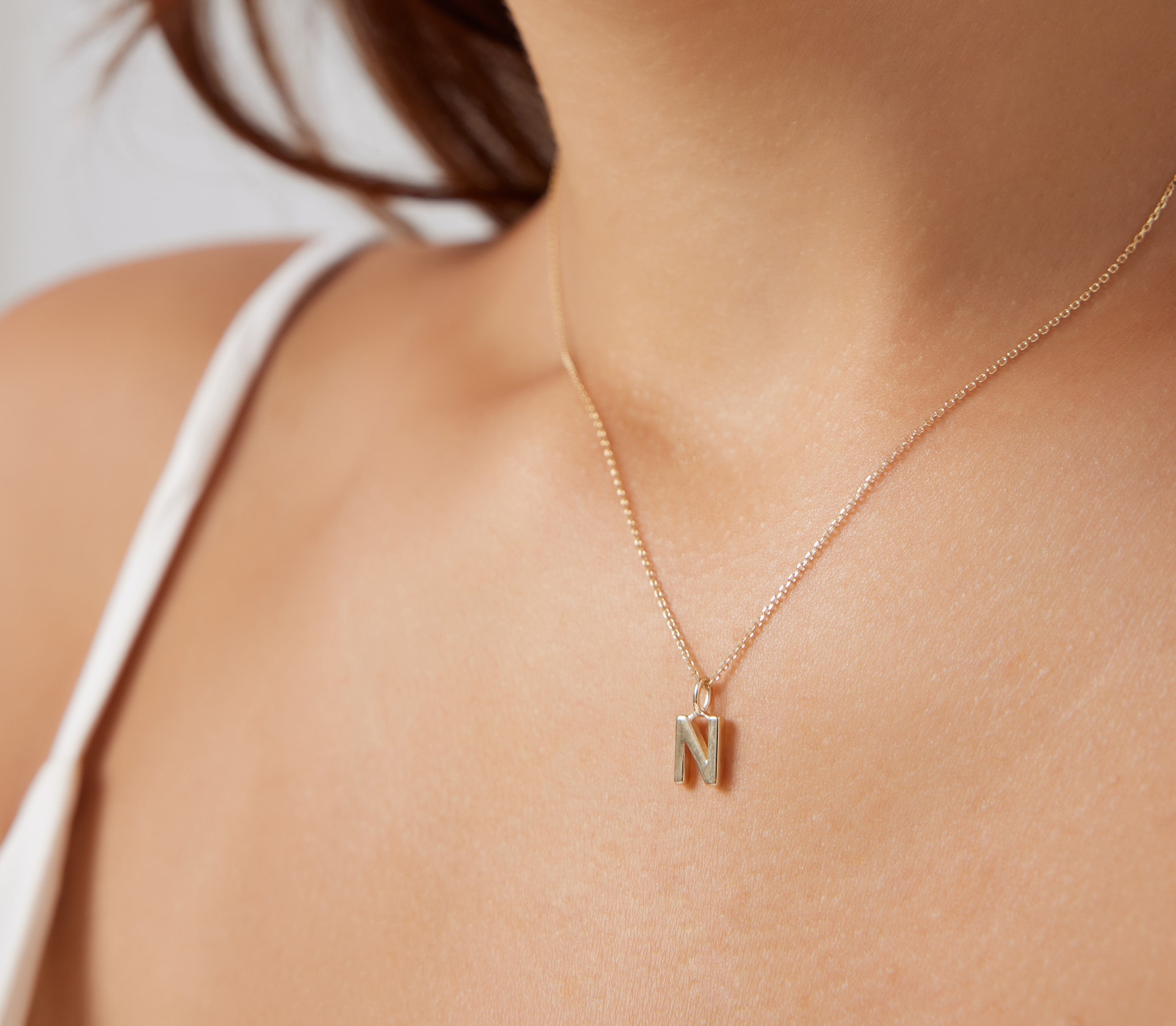 14K solid yellow gold initial necklace featuring letter N, dainty design, perfect for personalized jewelry.