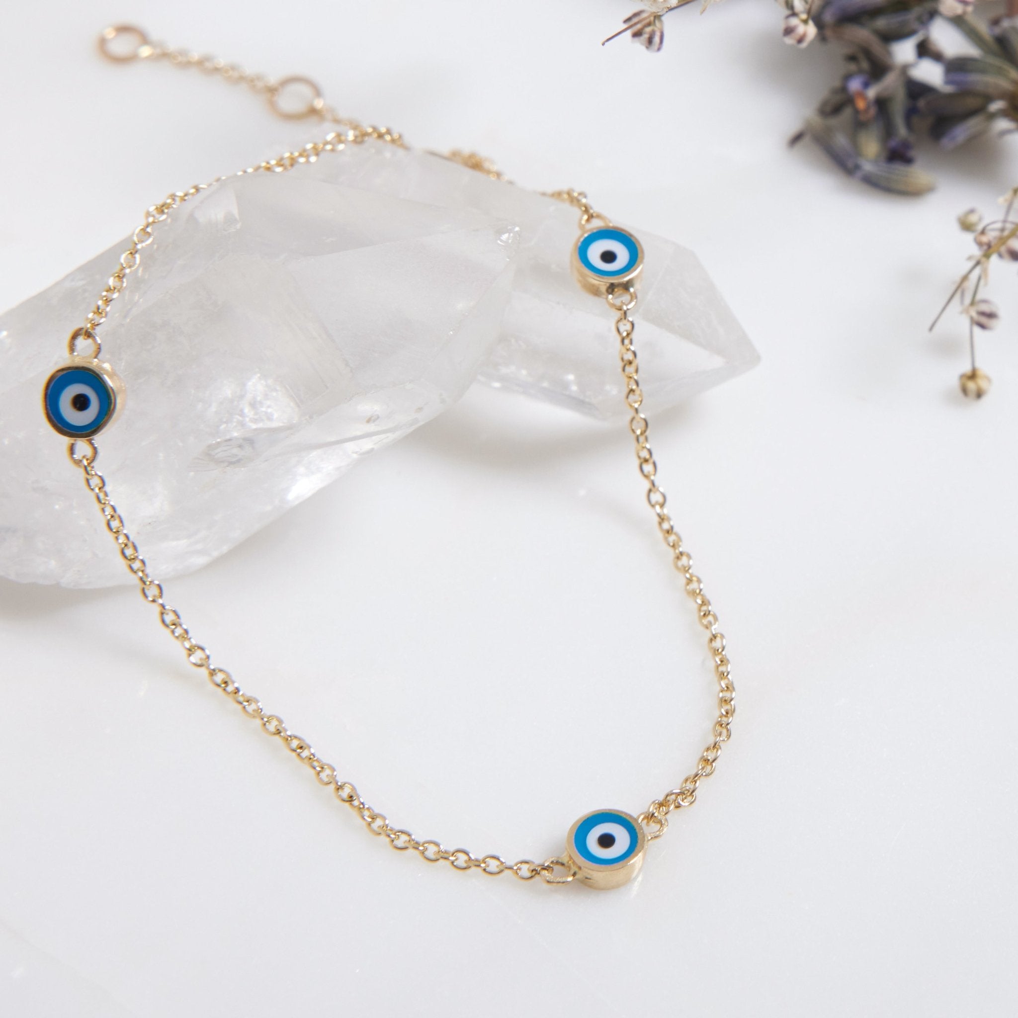 14K solid yellow gold minimalist evil eye bracelet with dainty blue evil eye stations, perfect for everyday wear.