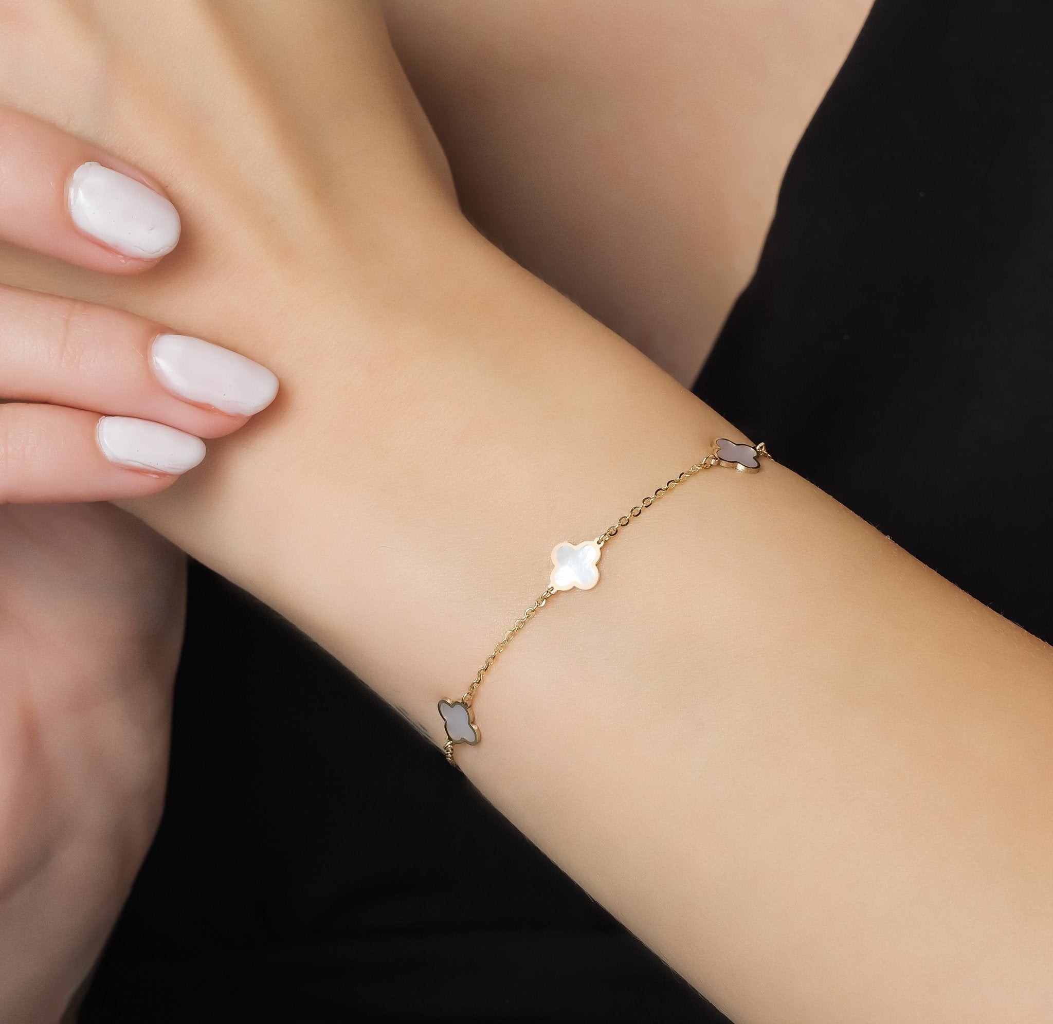 14K solid yellow gold bracelet with mother of pearl four leaf clover charms, perfect for everyday wear.