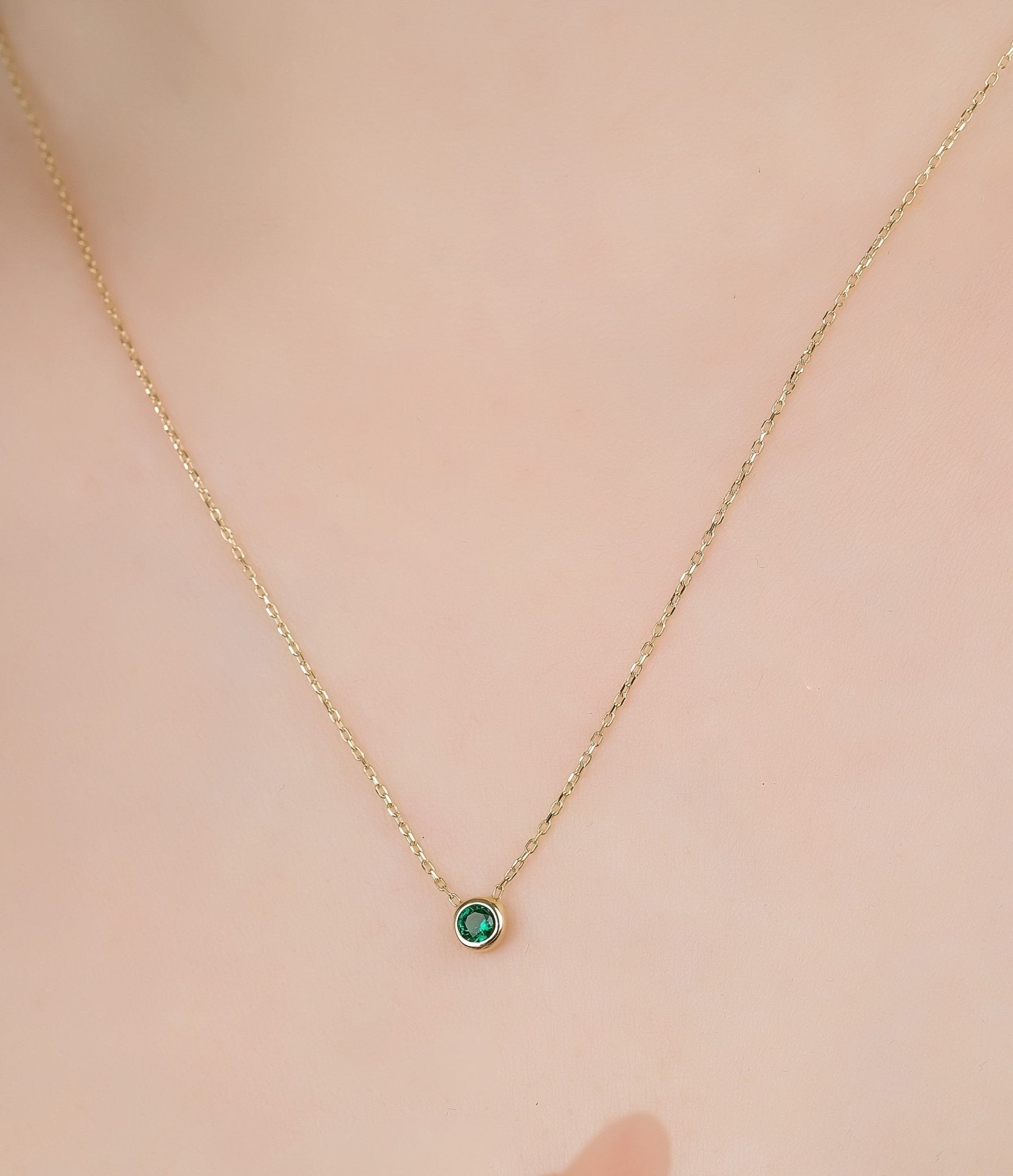 14K solid yellow gold necklace featuring a 0.30 carat solitaire emerald, delicate and perfect for everyday wear.