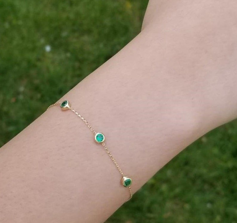 14K solid yellow gold station bracelet with three lab-created emeralds, delicate and perfect for everyday wear.