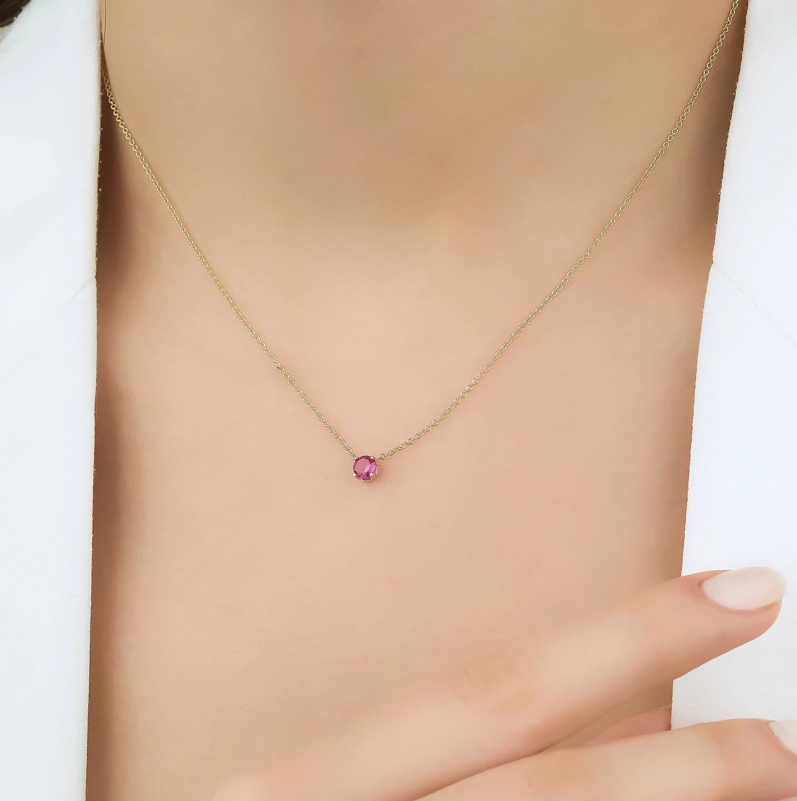 14K white gold prong setting solitaire ruby necklace worn, showing 5mm lab created ruby pendant.