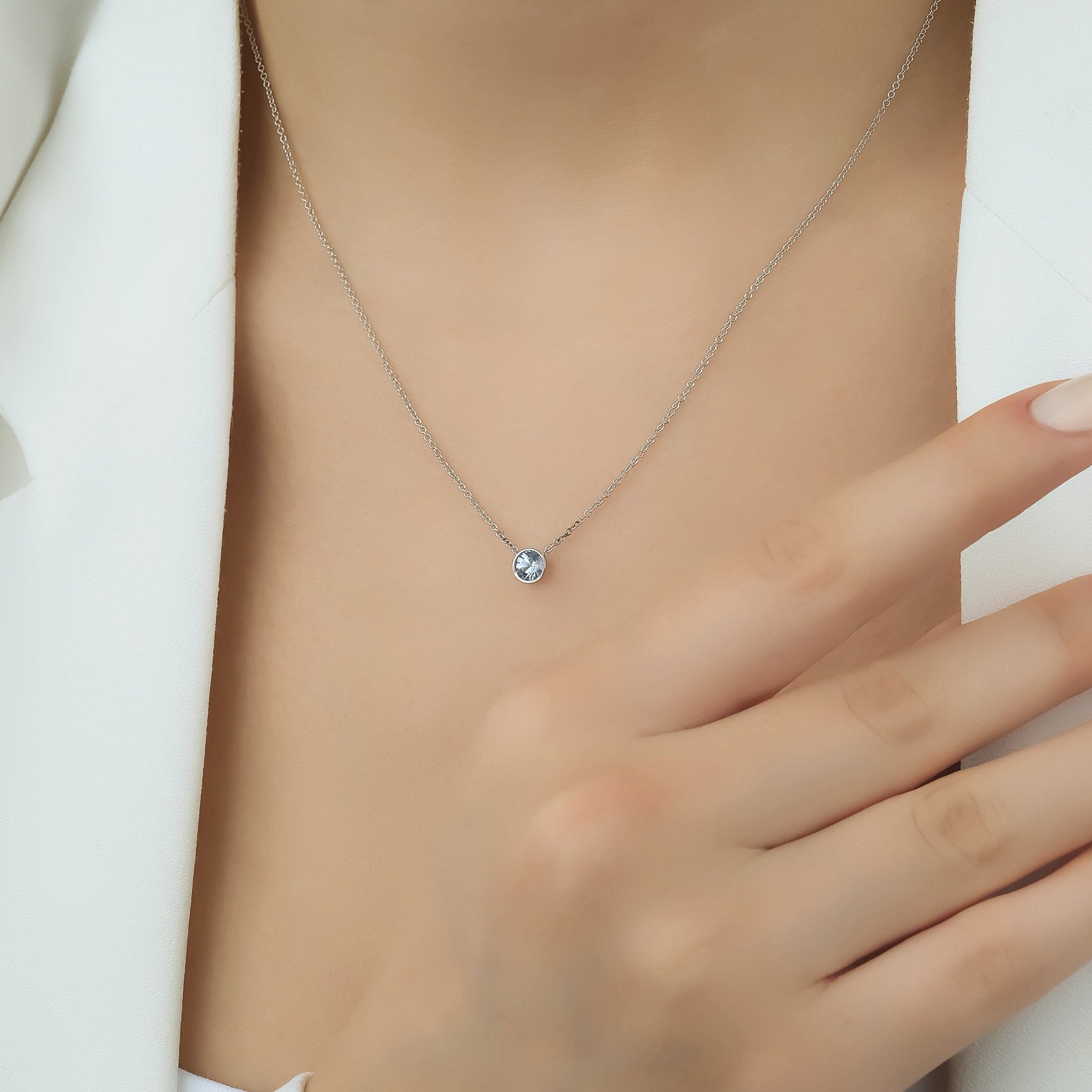 14K white gold minimalist aquamarine solitaire necklace worn on model, showcasing 4mm bezel setting.