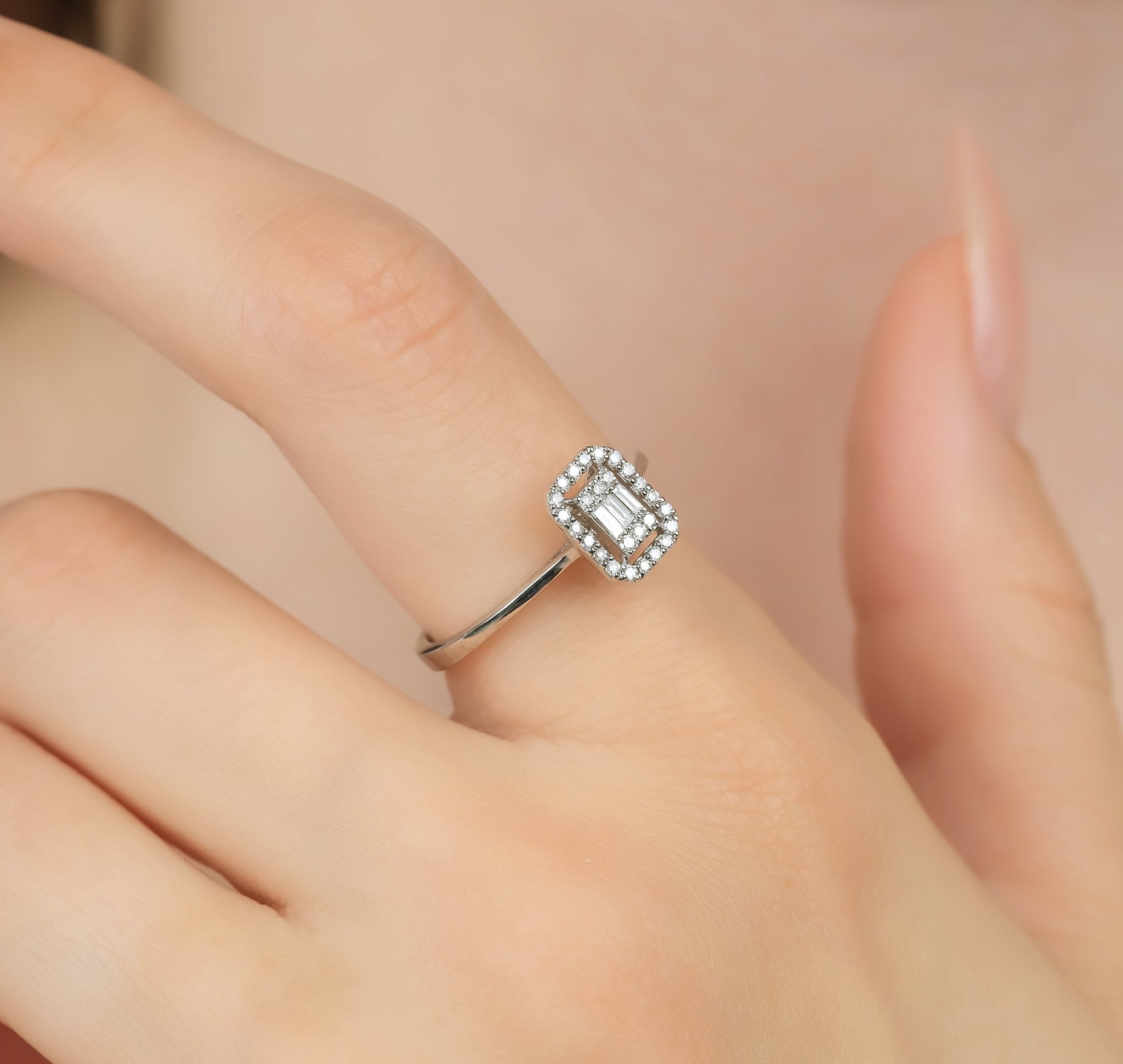 14K white gold baguette diamond wedding ring displayed on a finger, featuring round and baguette diamonds.