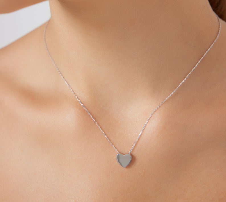 Dainty 14K white gold heart necklace displayed on a model's neck, perfect for minimalistic everyday wear.