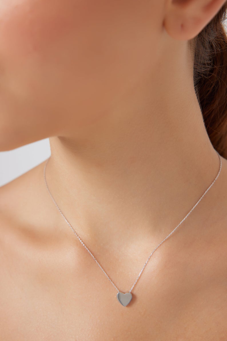 14K white gold dainty heart necklace worn by a model, showcasing its minimalist design and delicate charm.