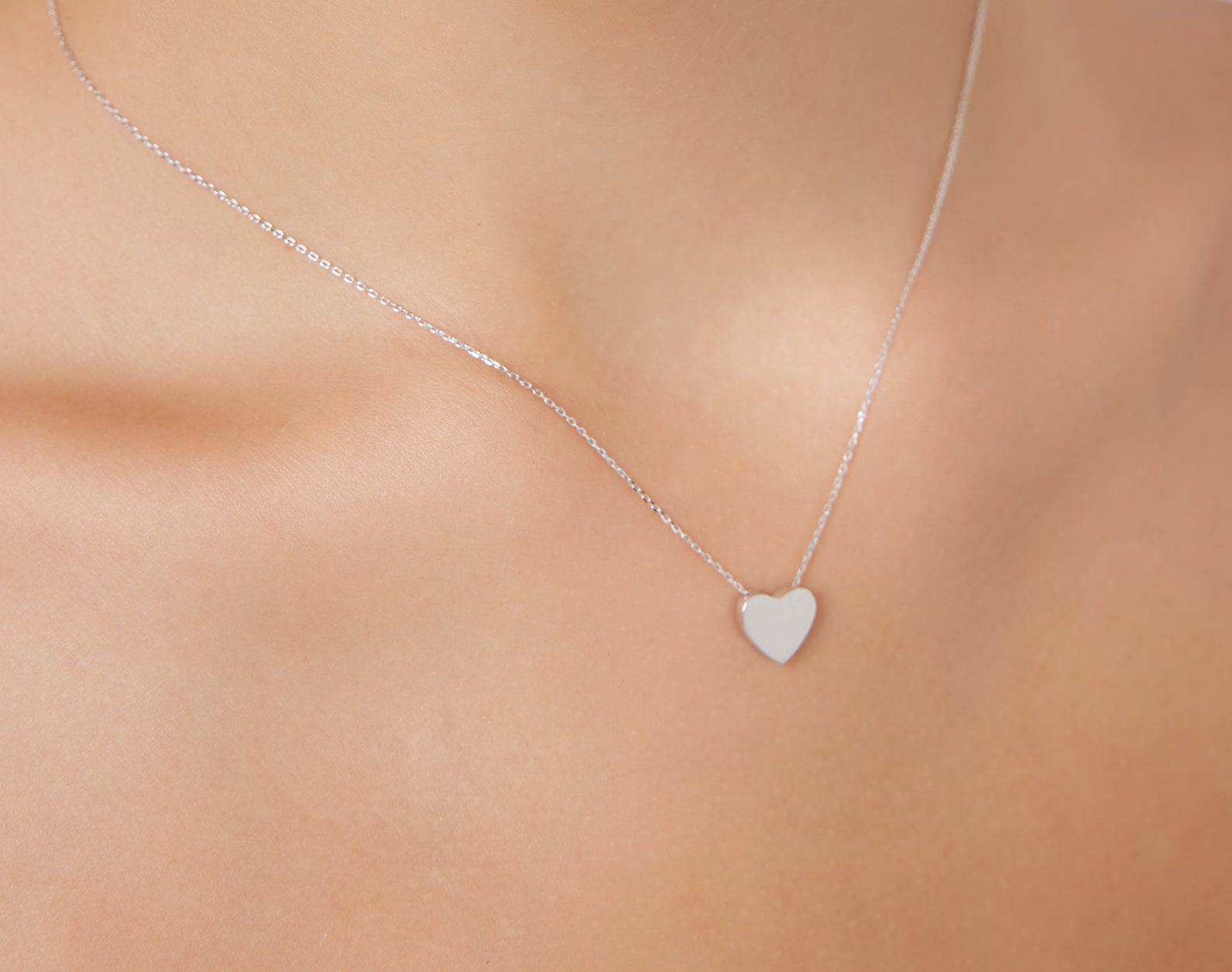 14K white gold dainty heart necklace showcased on a model, featuring a minimalist open back design.