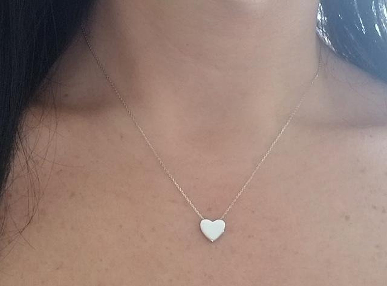 14K white gold dainty heart necklace worn close-up on a woman's neck, showcasing minimalist design.