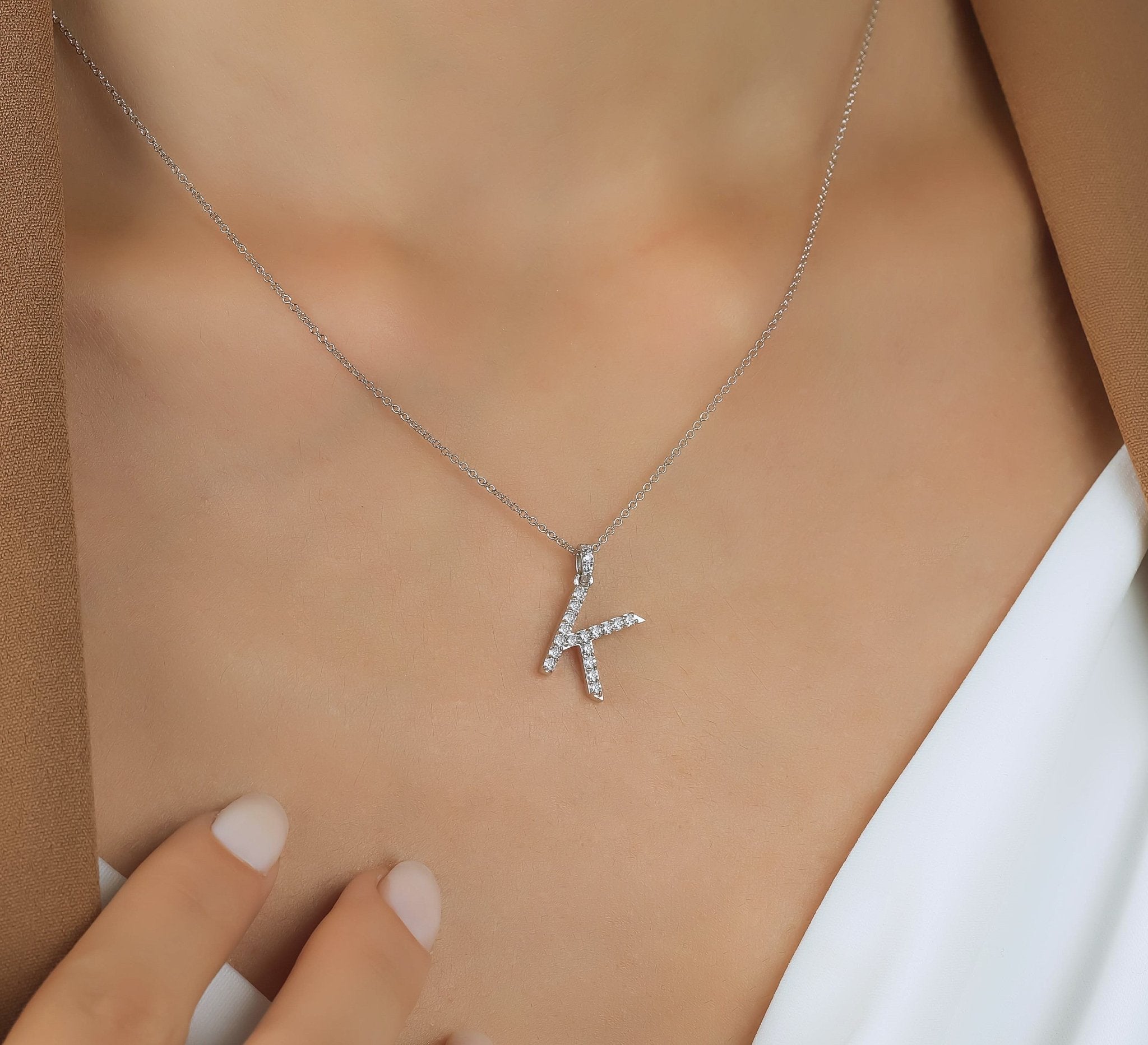 14K white gold initial necklace with diamond letter K, showcasing sparkle and elegance.