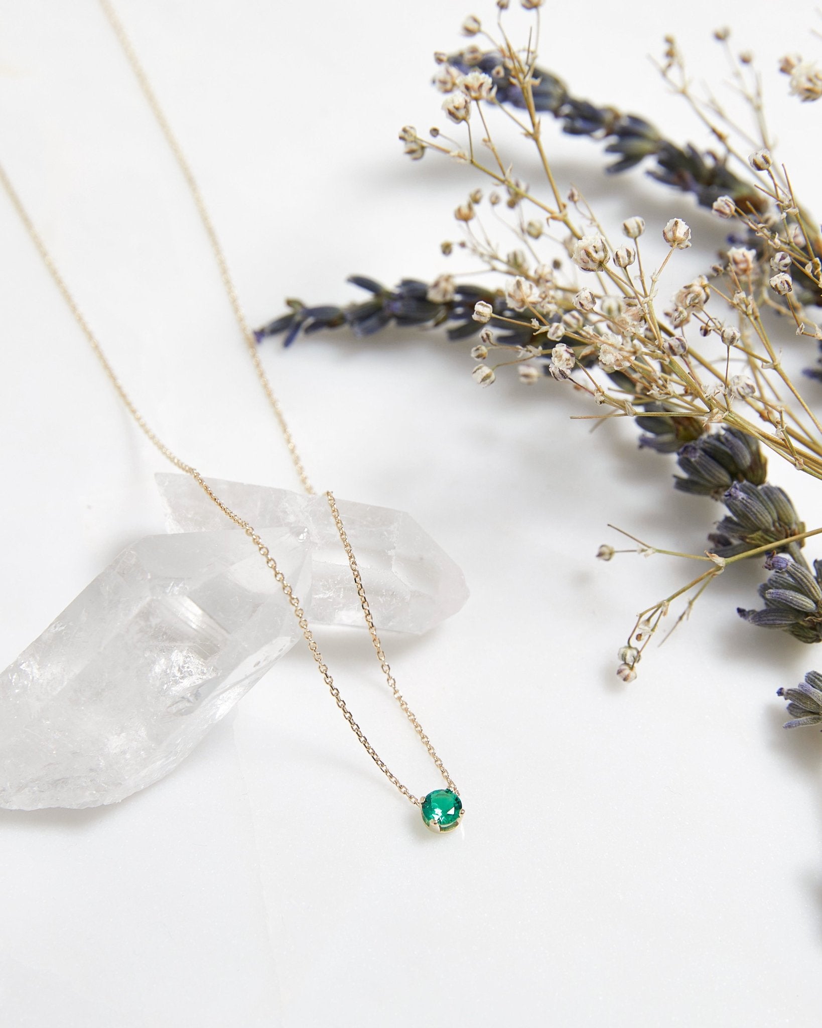 14K white gold minimalist solitaire emerald necklace on a crystal with dried flowers, 16 inches length, May birthstone.