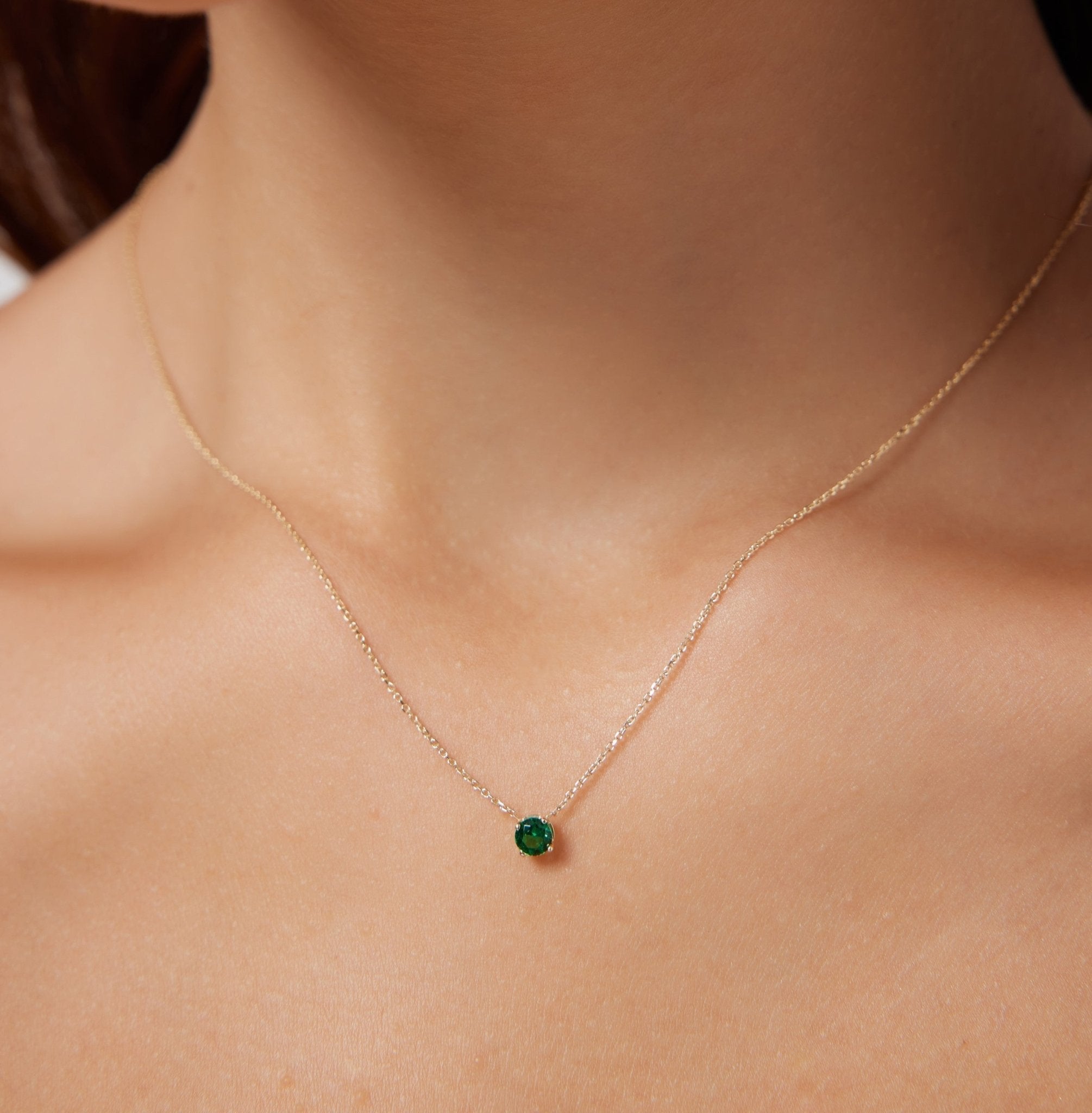 Dainty 14K white gold necklace featuring a 5mm prong set minimalist emerald gemstone, ideal for everyday wear.