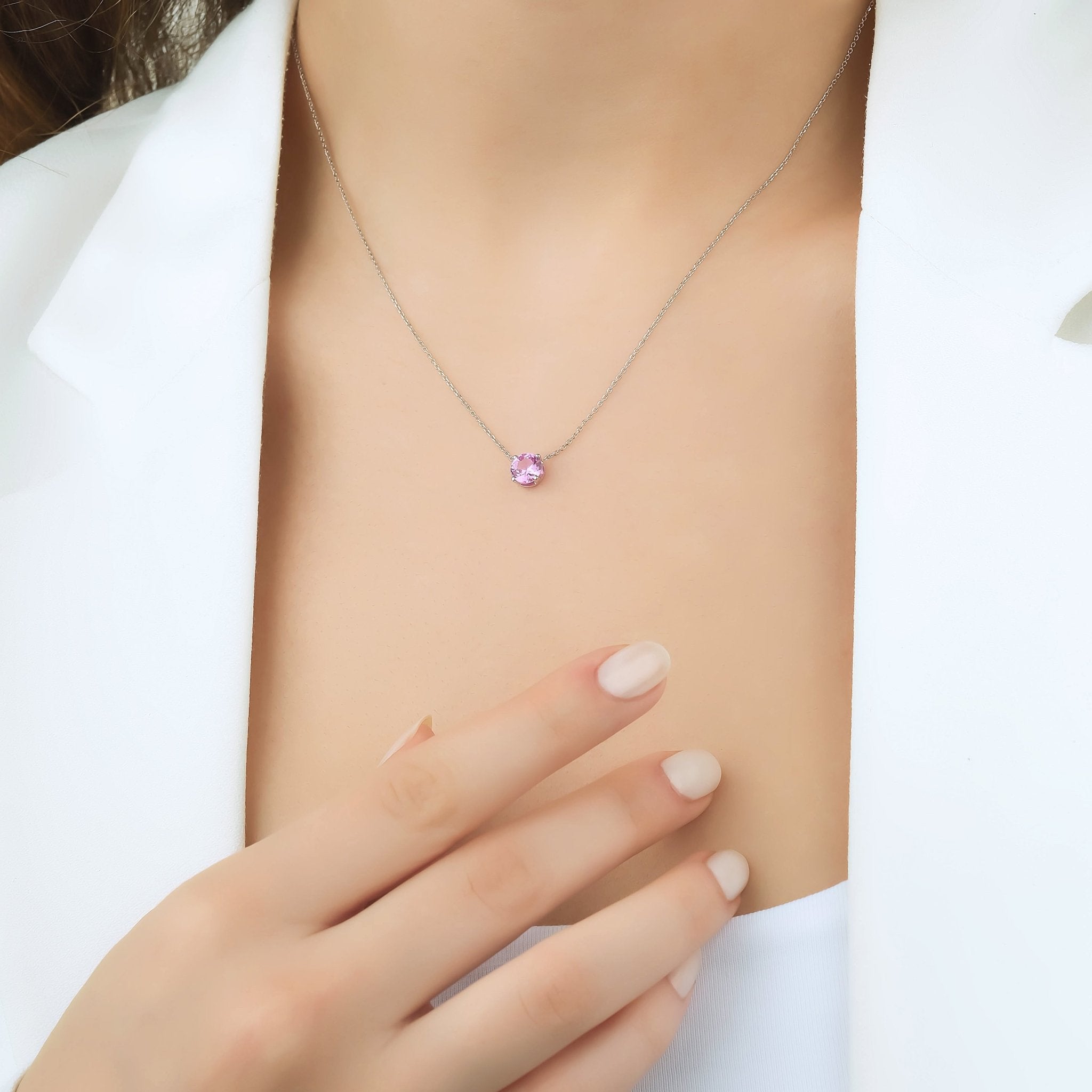 14K white gold 6mm pink sapphire solitaire necklace worn on a model, featuring a delicate and classy design.